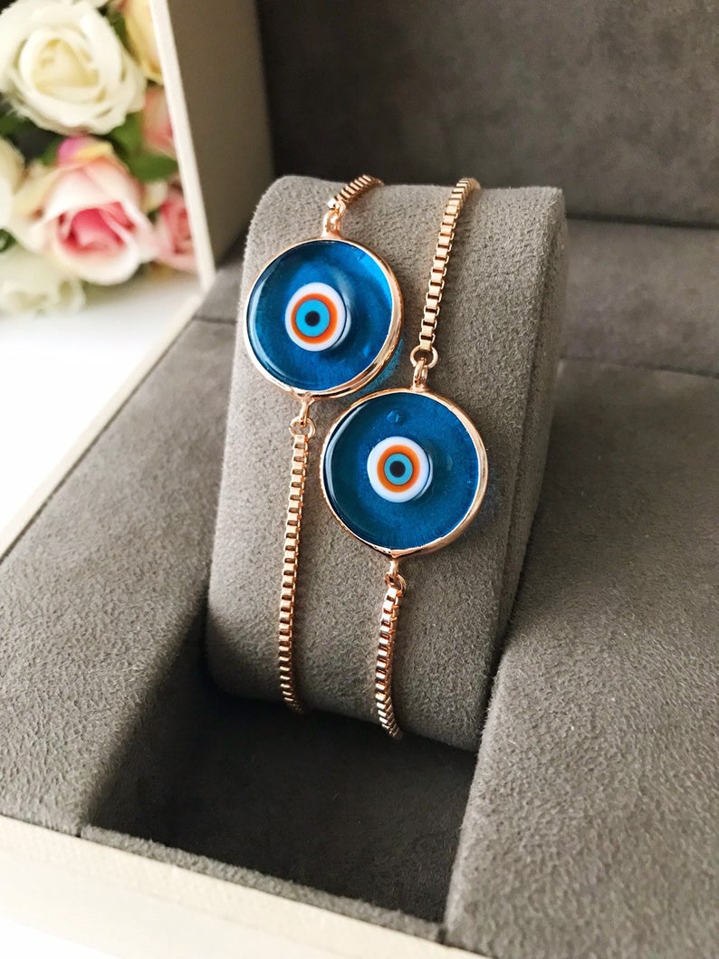 Murano Evil Eye Bracelet featuring a turquoise charm on an adjustable rose gold chain, showcasing intricate handmade details.