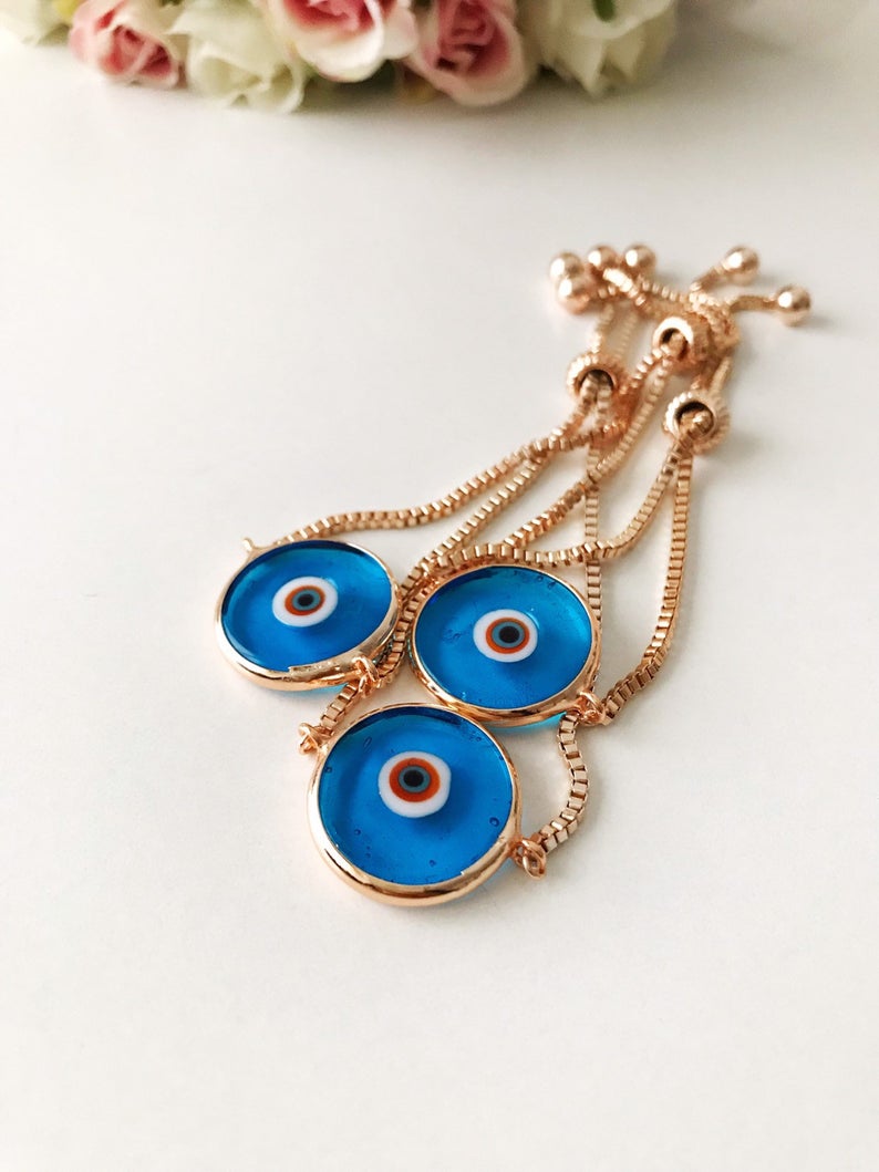 Murano Evil Eye Bracelet featuring a turquoise charm on an adjustable rose gold chain, showcasing intricate handmade details.