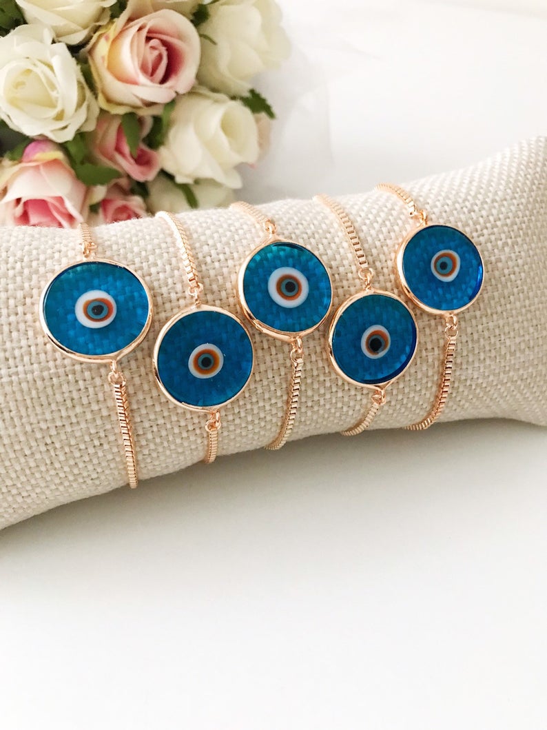 Murano Evil Eye Bracelet featuring a turquoise charm on an adjustable rose gold chain, showcasing intricate handmade details.