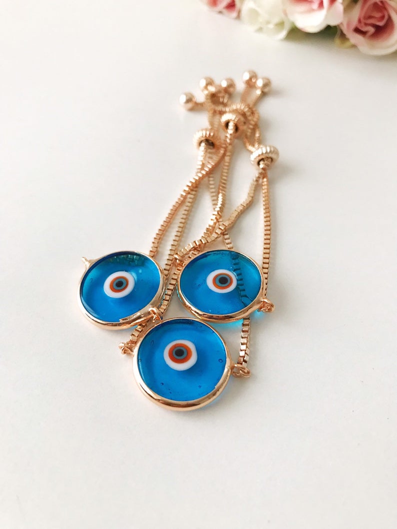 Murano Evil Eye Bracelet featuring a turquoise charm on an adjustable rose gold chain, showcasing intricate handmade details.