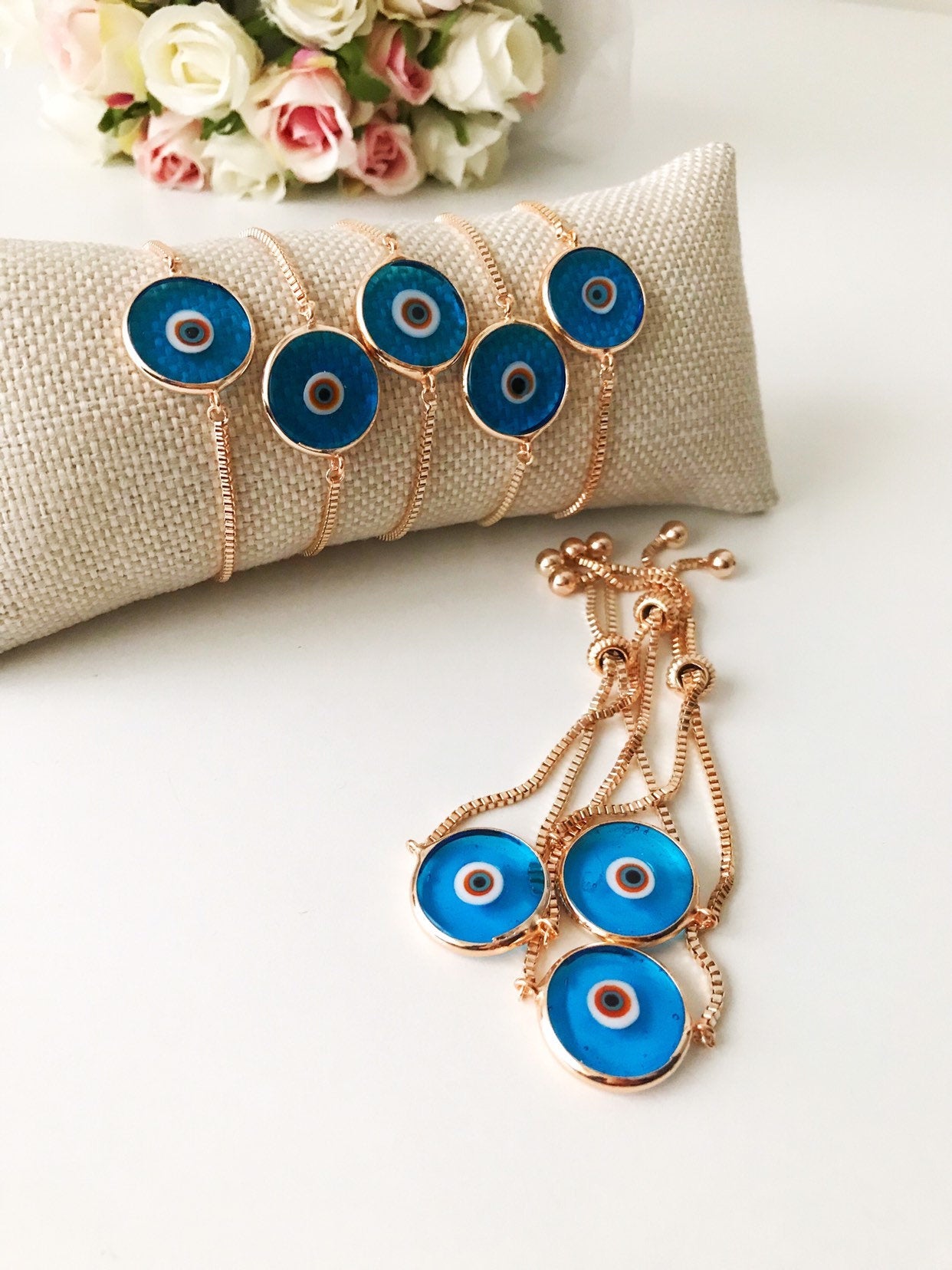 Murano Evil Eye Bracelet featuring a turquoise charm on an adjustable rose gold chain, showcasing intricate handmade details.