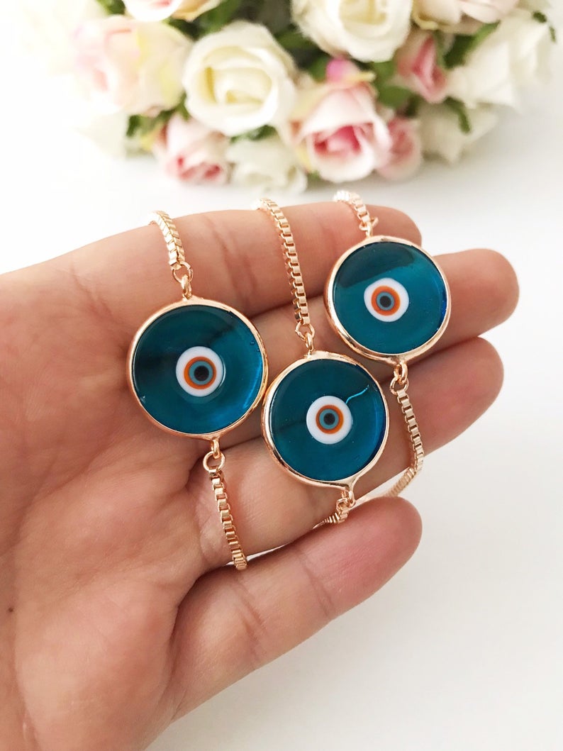 Murano Evil Eye Bracelet featuring a turquoise charm on an adjustable rose gold chain, showcasing intricate handmade details.