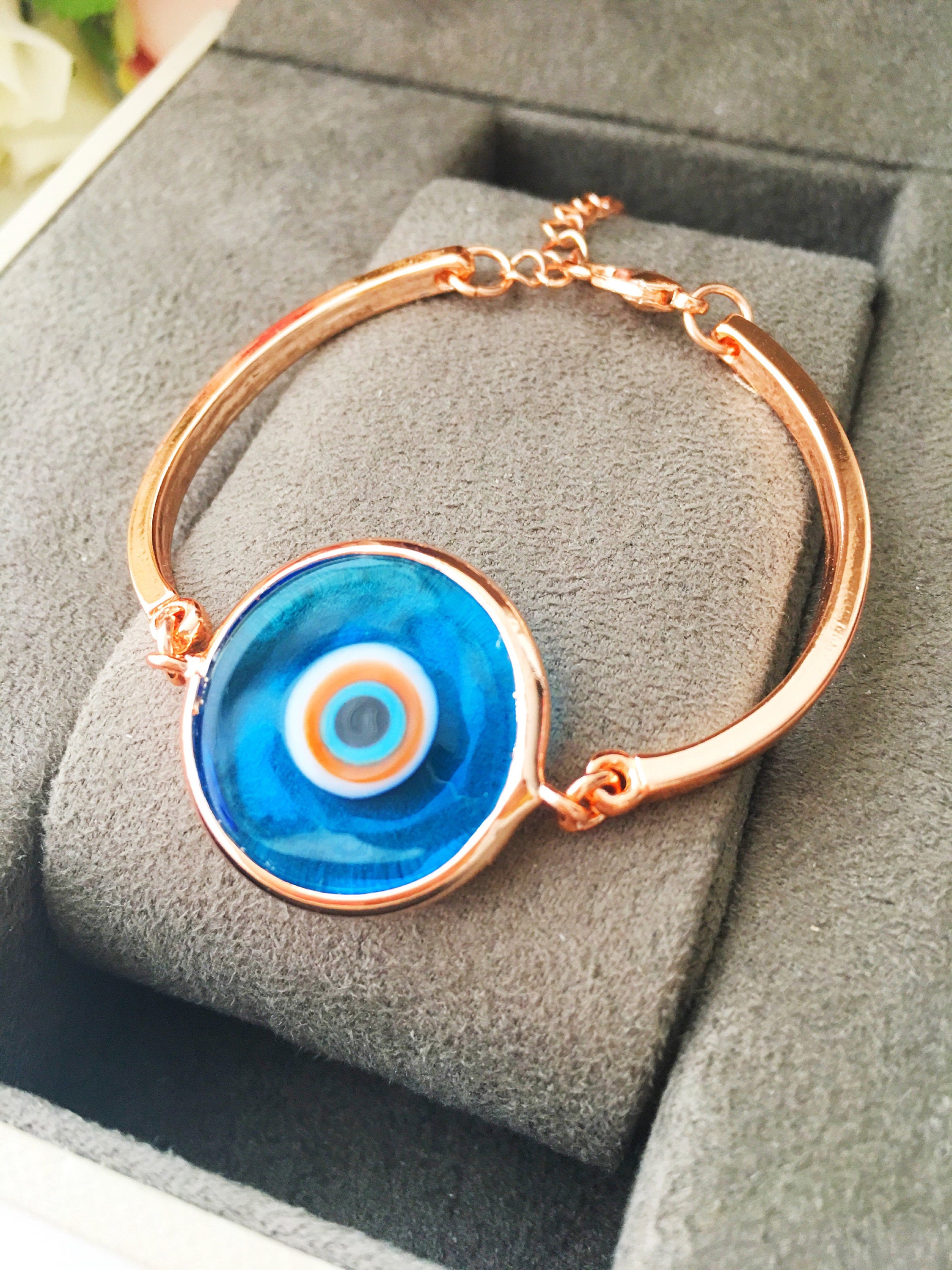 Murano Evil Eye Bracelet in rose gold featuring a blue evil eye charm and adjustable stainless steel band.