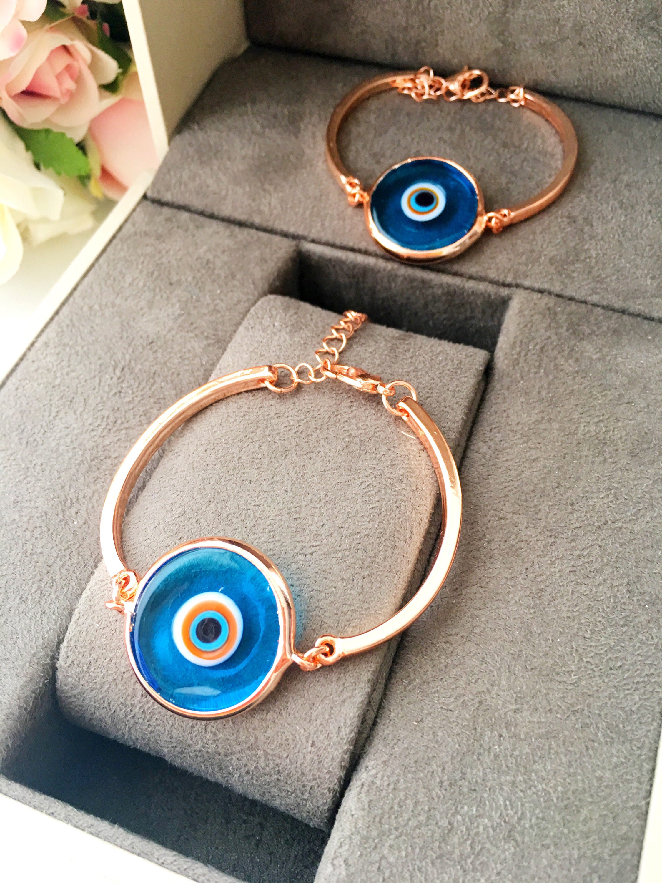 Murano Evil Eye Bracelet in rose gold featuring a blue evil eye charm and adjustable stainless steel band.