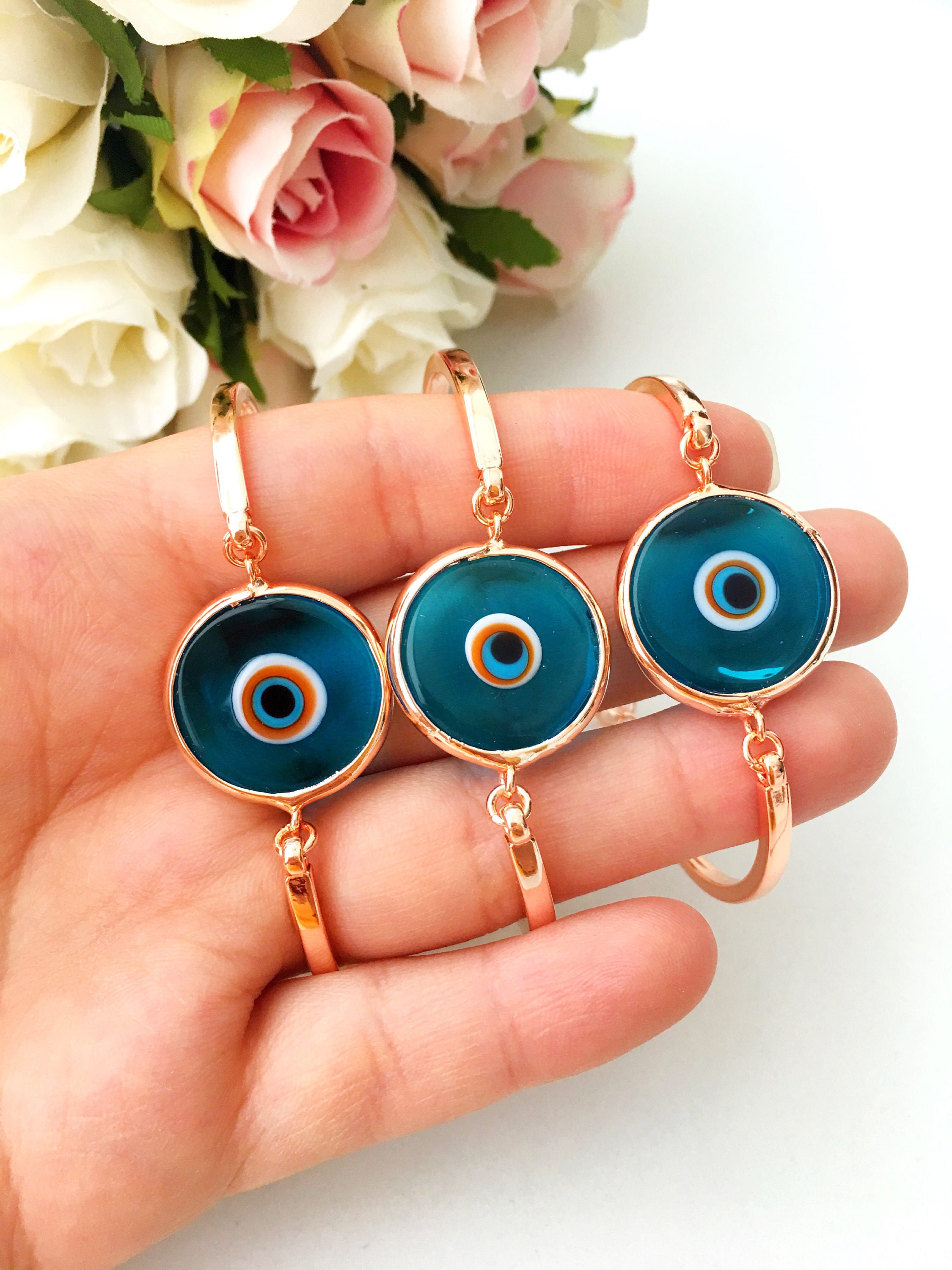 Murano Evil Eye Bracelet in rose gold featuring a blue evil eye charm and adjustable stainless steel band.