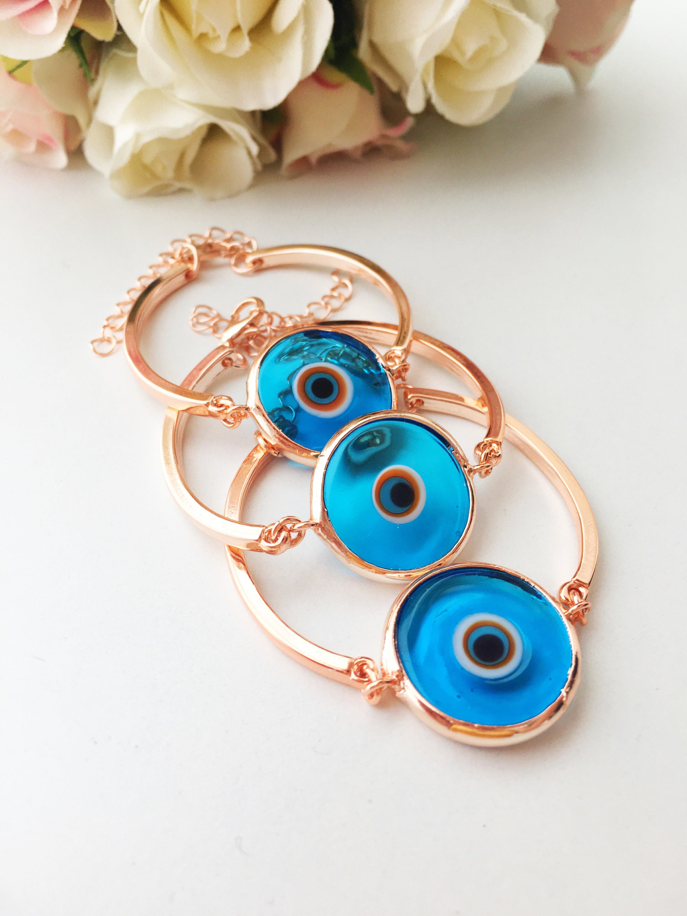 Murano Evil Eye Bracelet in rose gold featuring a blue evil eye charm and adjustable stainless steel band.