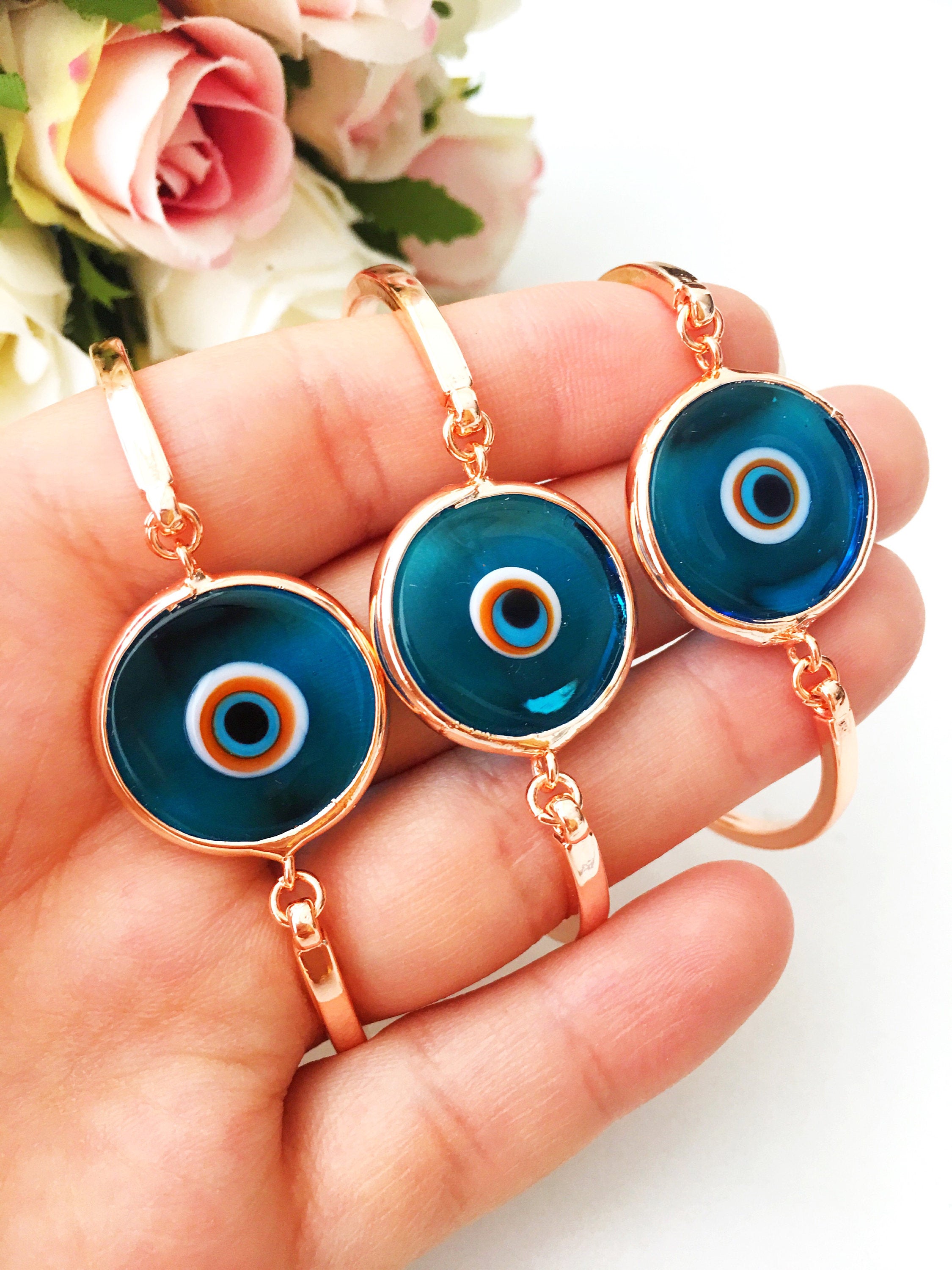 Murano Evil Eye Bracelet in rose gold featuring a blue evil eye charm and adjustable stainless steel band.