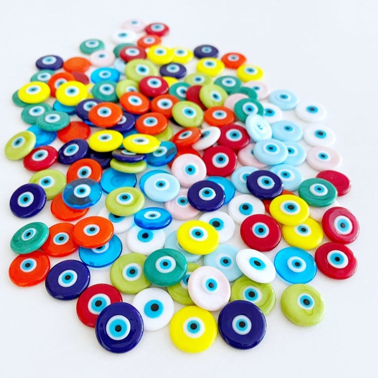 A collection of 15mm Murano Evil Eye Cabochons in various colors, showcasing their intricate designs and glass craftsmanship.