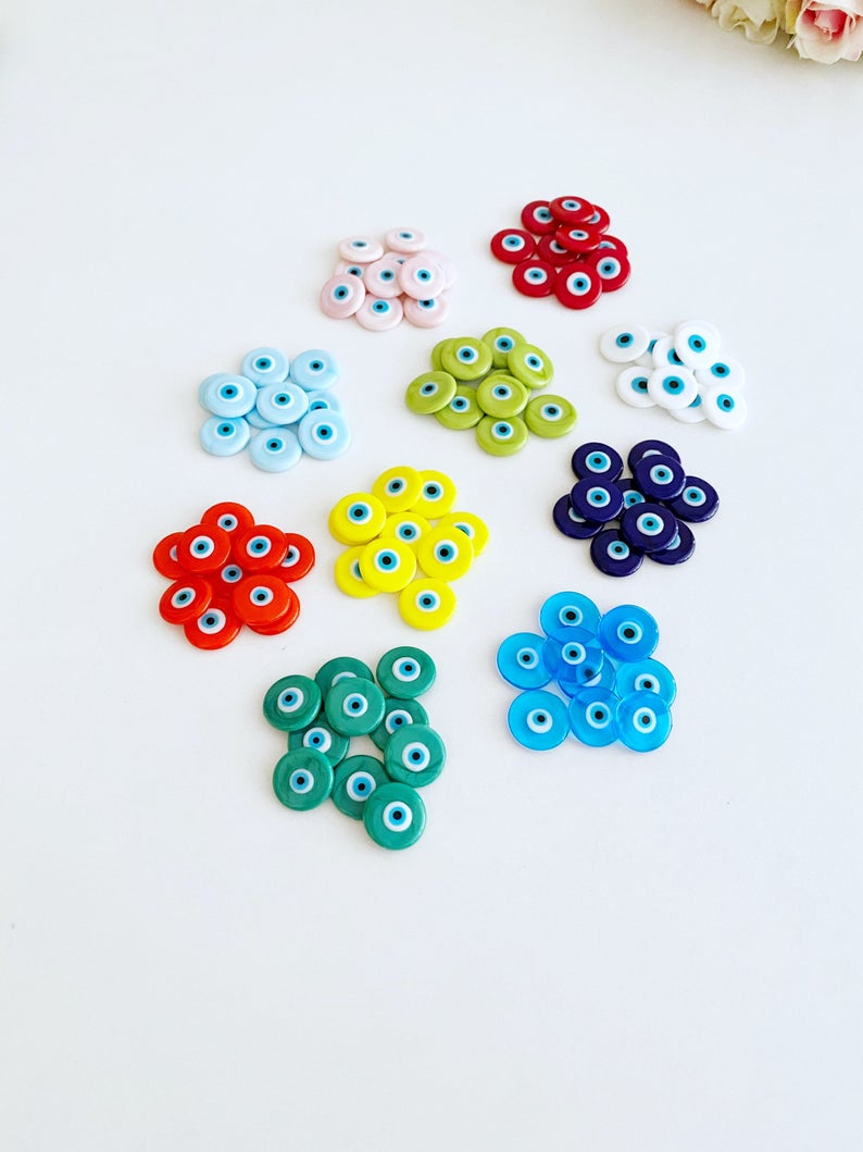 A collection of 15mm Murano Evil Eye Cabochons in various colors, showcasing their intricate designs and glass craftsmanship.