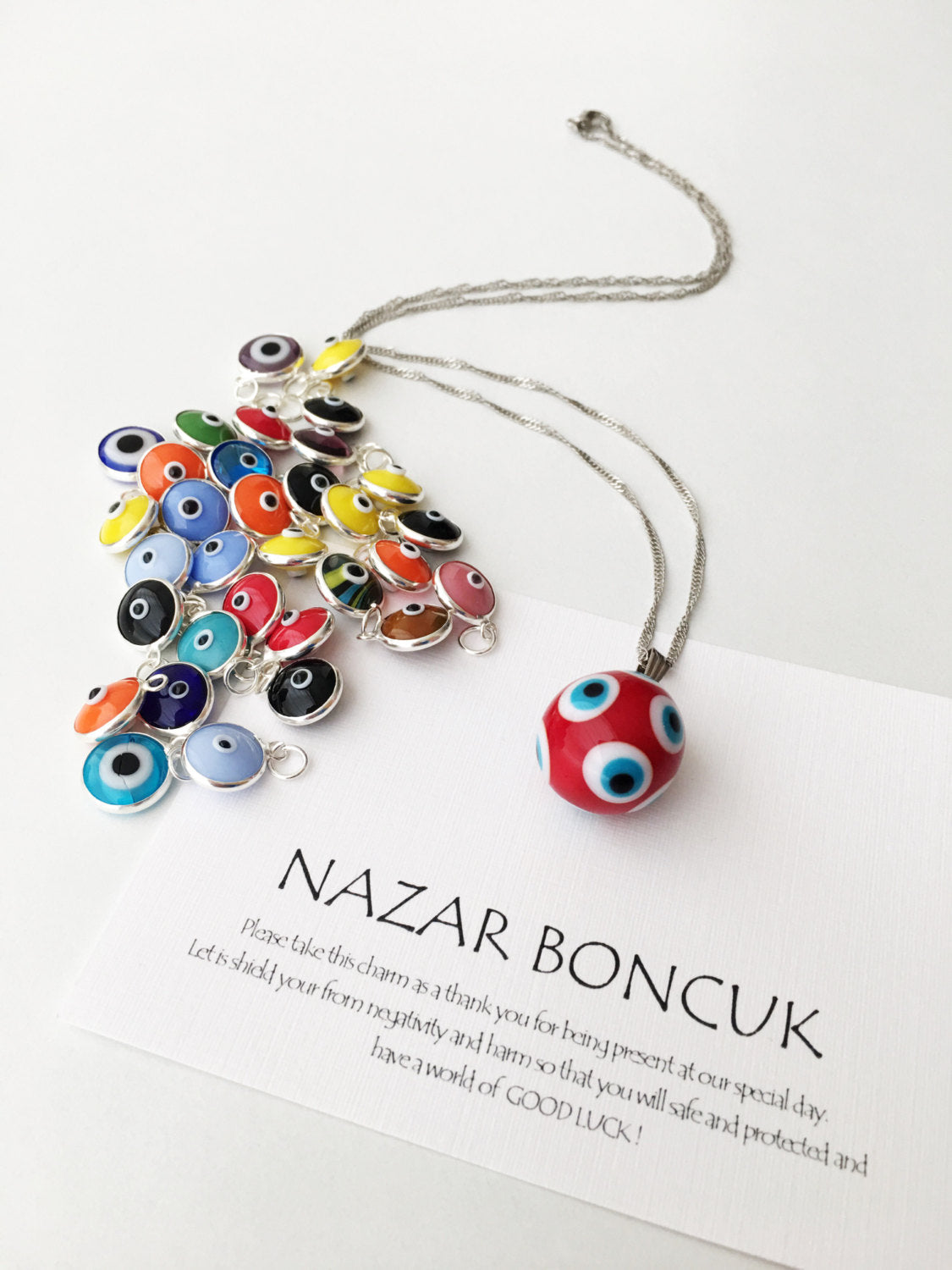 Murano Evil Eye Necklace featuring a large blue and red evil eye bead with a tiny white evil eye bead, showcasing intricate glass craftsmanship.