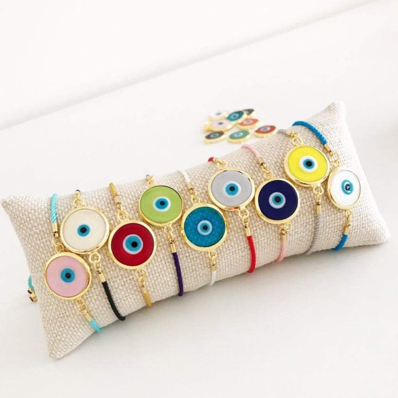 Murano Glass Evil Eye Bracelet featuring a vibrant glass charm on an adjustable cotton cord, showcasing its handmade craftsmanship.