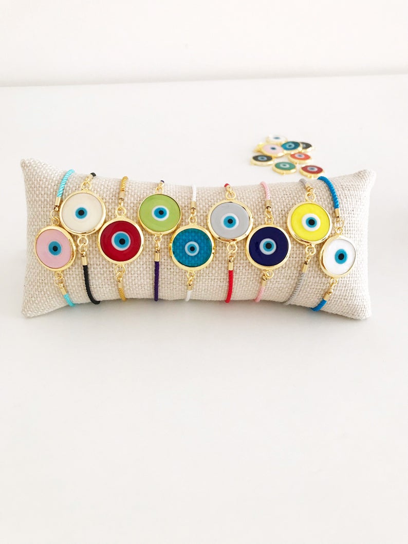 Murano Glass Evil Eye Bracelet featuring a vibrant glass charm on an adjustable cotton cord, showcasing its handmade craftsmanship.