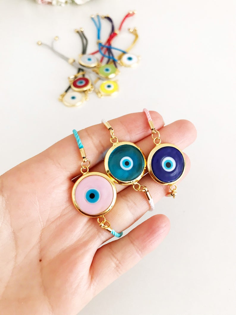 Murano Glass Evil Eye Bracelet featuring a vibrant glass charm on an adjustable cotton cord, showcasing its handmade craftsmanship.