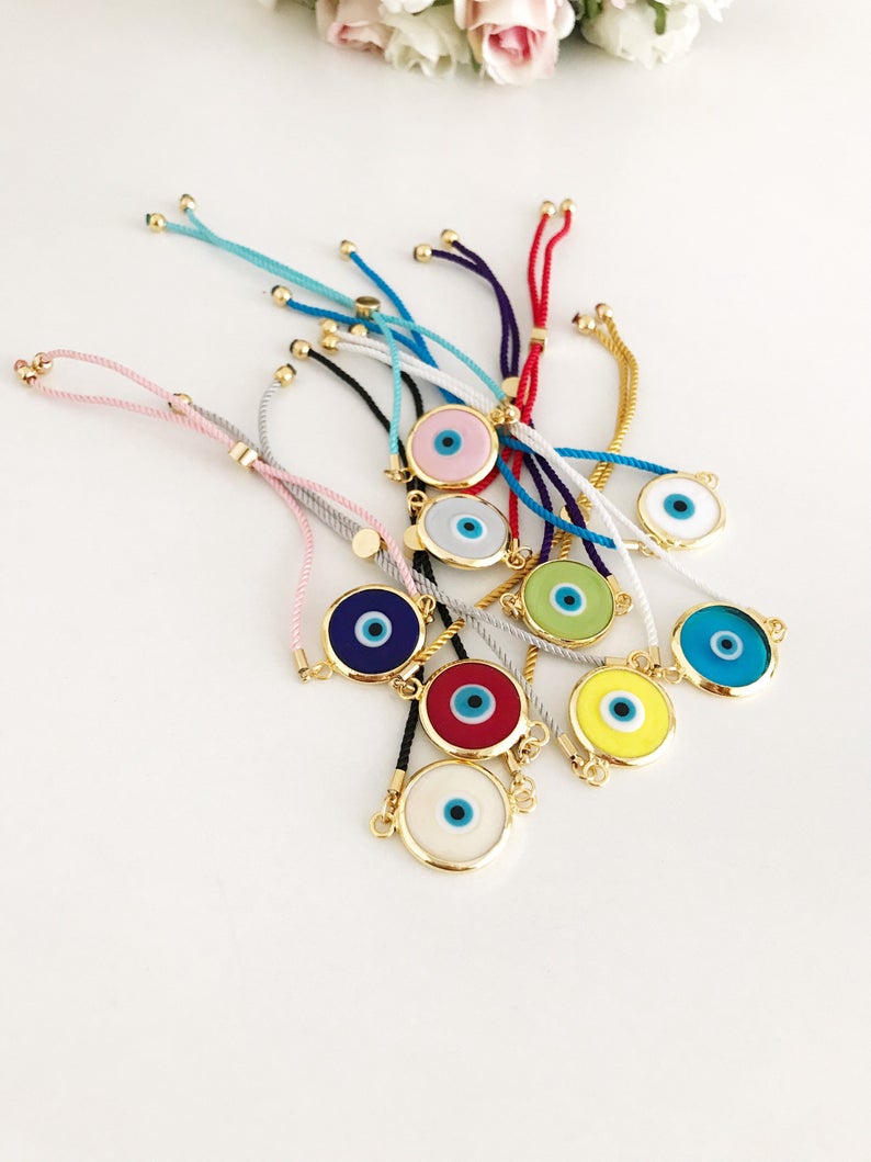Murano Glass Evil Eye Bracelet featuring a vibrant glass charm on an adjustable cotton cord, showcasing its handmade craftsmanship.