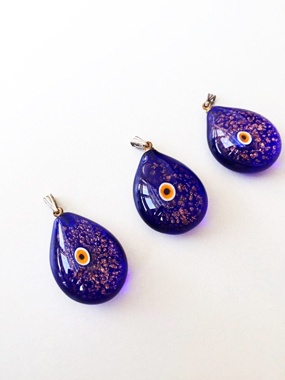 Handcrafted Murano glass evil eye pendant in vibrant blue, featuring intricate lampwork design, symbolizing protection and style.