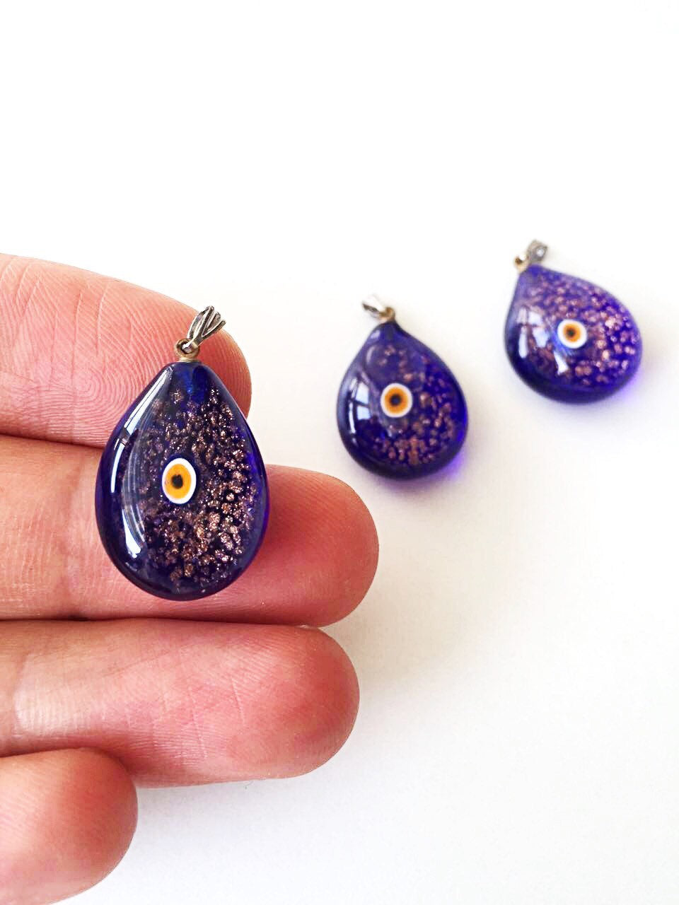 Handcrafted Murano glass evil eye pendant in vibrant blue, featuring intricate lampwork design, symbolizing protection and style.