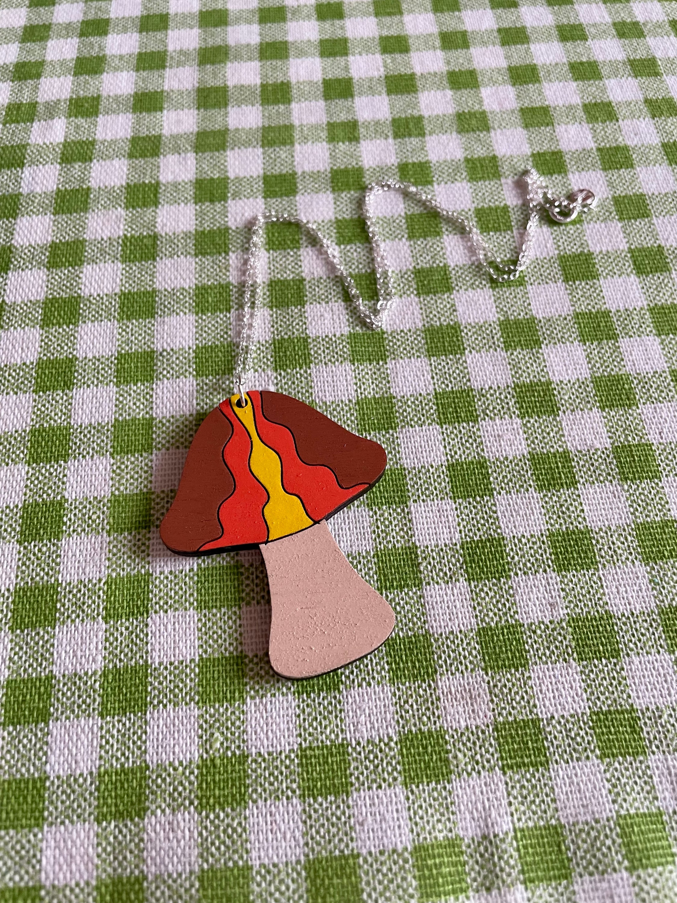 A stylish Mushroom Necklace: Waves made from laser-cut Birch Plywood, featuring a unique mushroom design on a sterling silver chain.