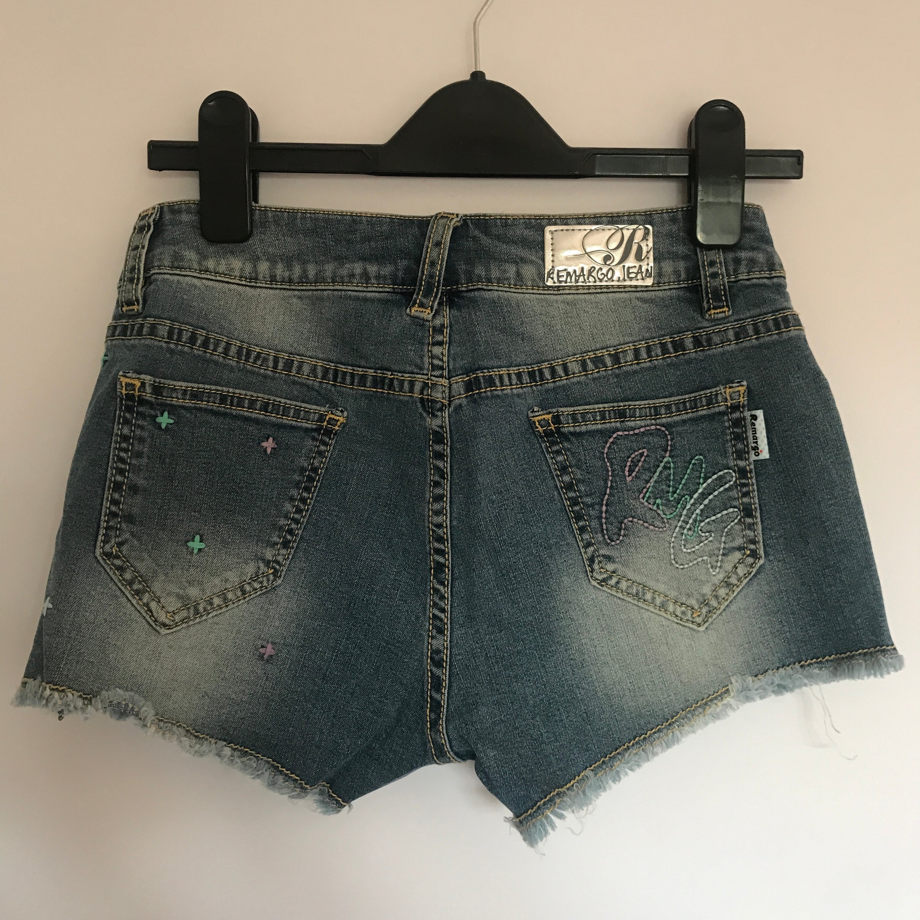 A pair of stylish denim shorts featuring a unique music notes design, made from a comfortable cotton and spandex blend.