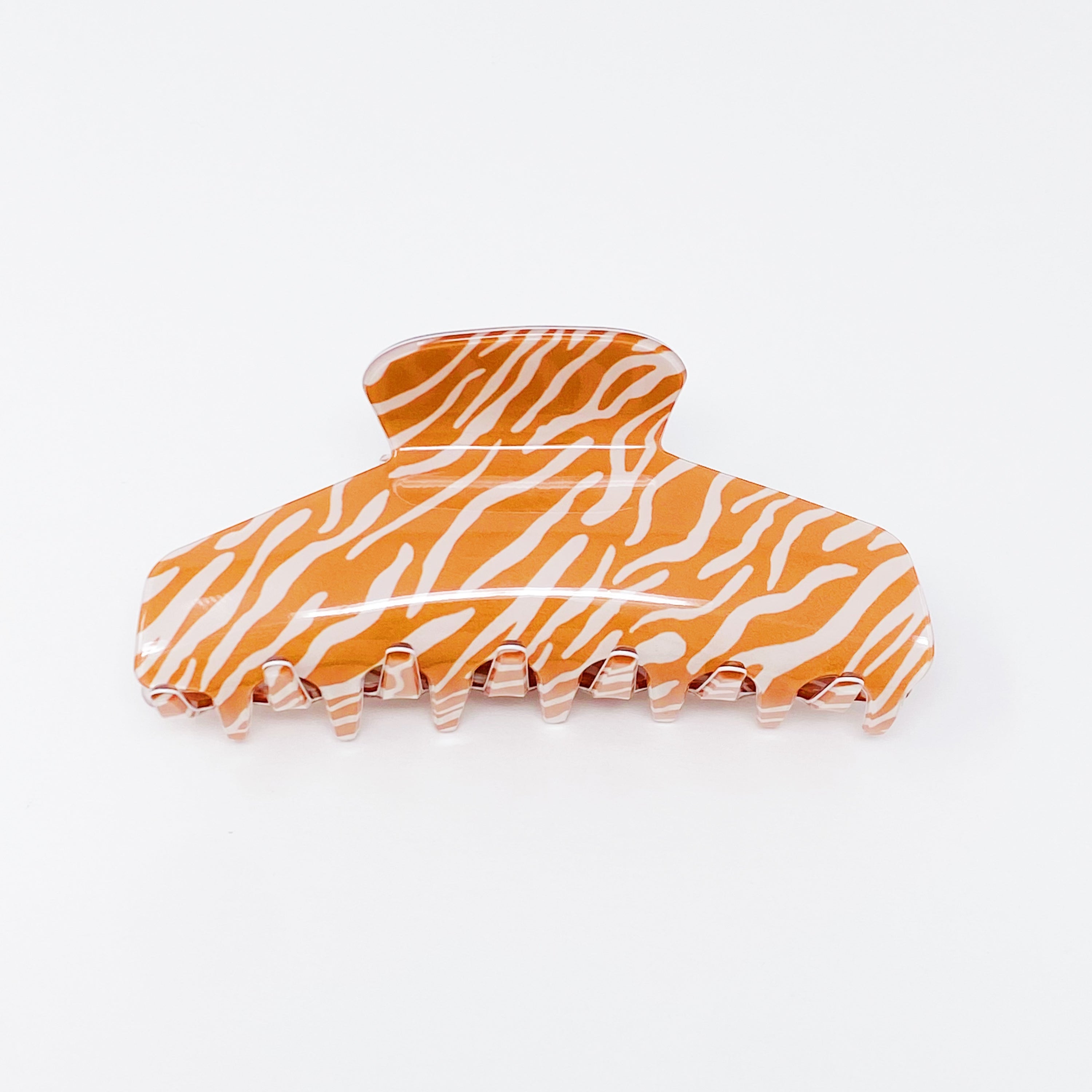 Muted zebra print hair claw clip made of durable acrylic, designed to hold thick hair securely with a stylish aesthetic.