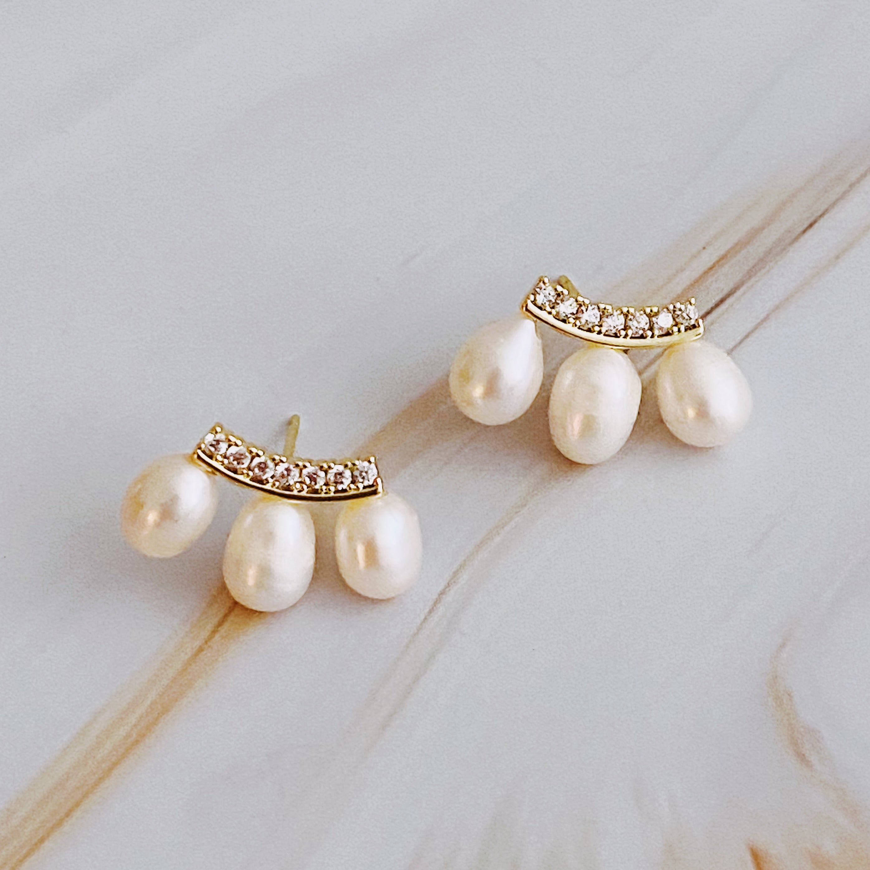 My Beauty Secret Mini Stud Earrings featuring elegant design with dainty jewels and pearl details, crafted from 18k gold plated brass.