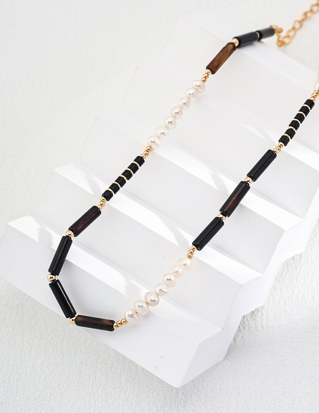 Mystic Noir Pearl & Onyx Necklace featuring luminous pearls and striking black onyx beads, elegantly designed for versatile styling.