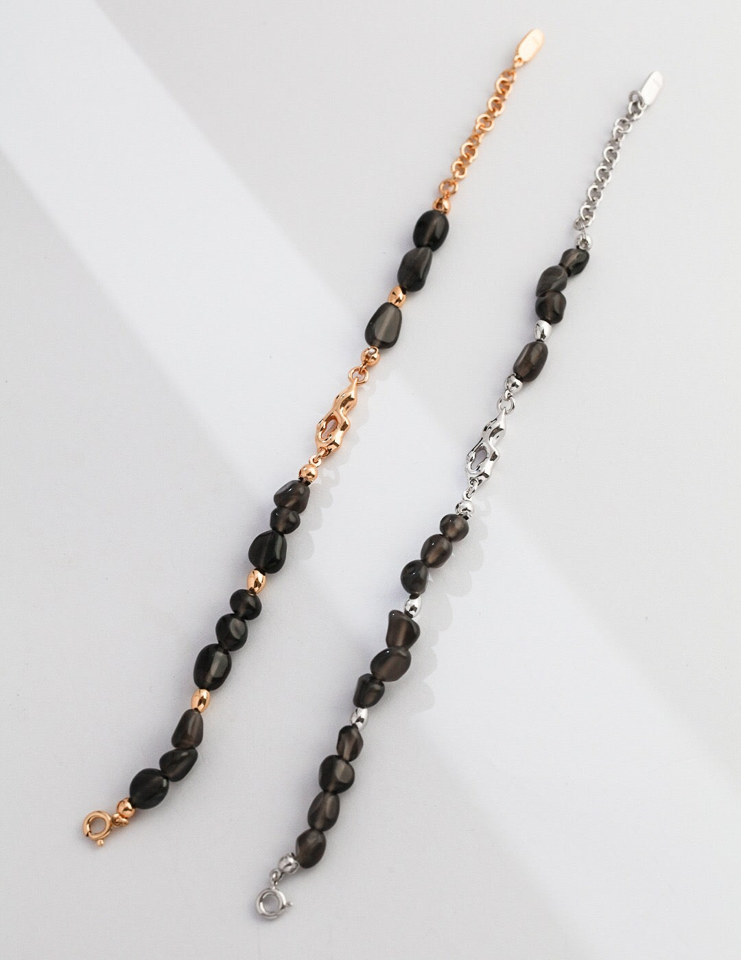 Natural Element Obsidian Stone Bracelet featuring black obsidian stones and gold vermeil accents, elegantly displayed on a soft fabric background.