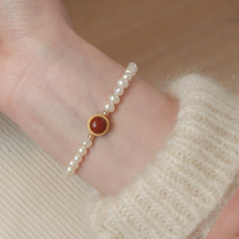 Natural Freshwater Pearl Bracelet featuring a vibrant red gemstone accent, showcasing elegant pearls and a striking design.