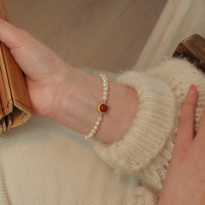 Natural Freshwater Pearl Bracelet featuring a vibrant red gemstone accent, showcasing elegant pearls and a striking design.