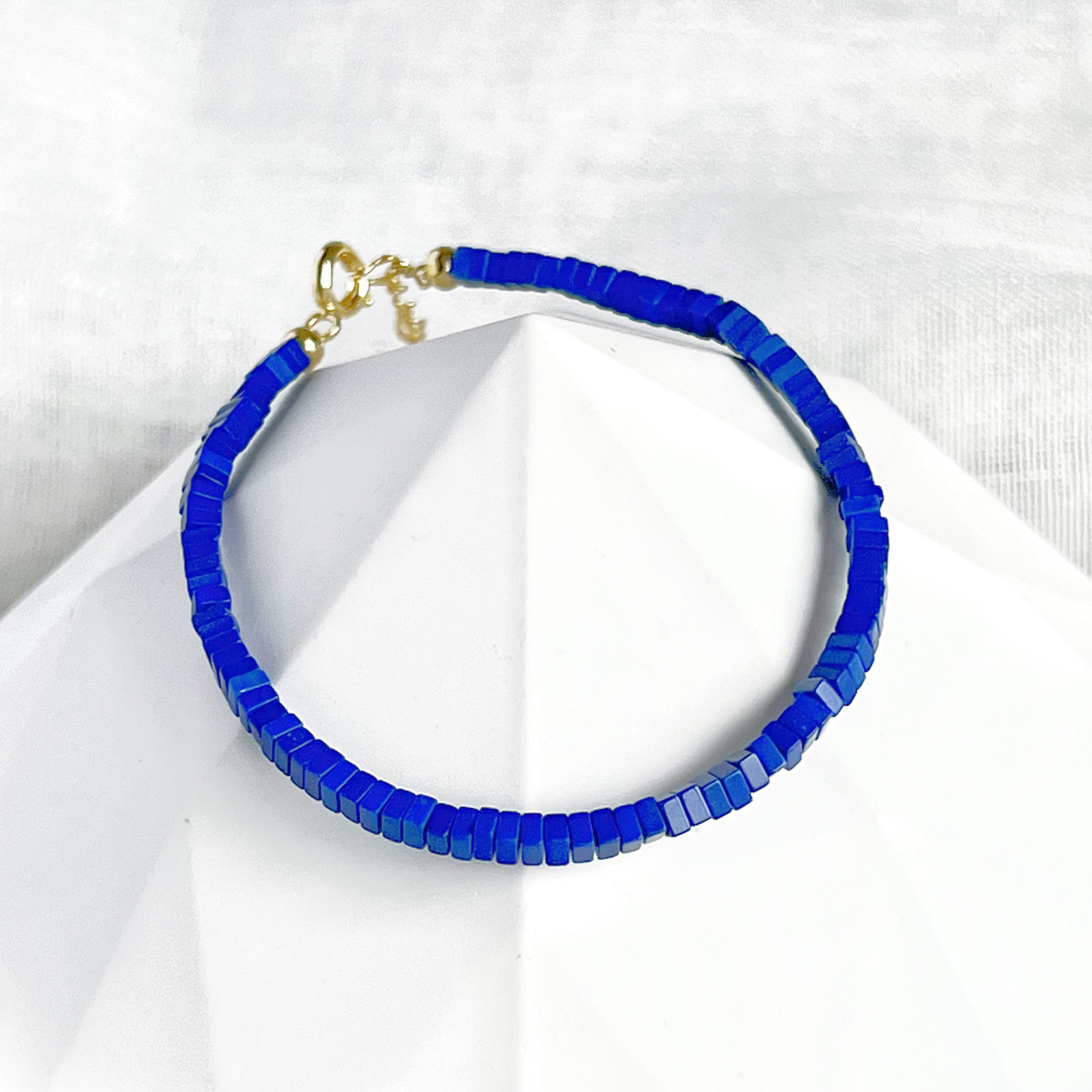 Natural Lapis Lazuli Square Beaded Bracelet with gold-plated bronze buckle, showcasing deep blue beads in a stylish design.