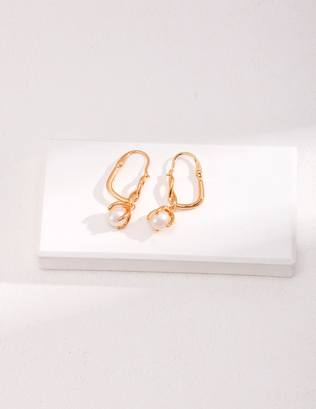 Elegant Natural Pearl Drop Earrings featuring gold vermeil, showcasing their unique design and craftsmanship.