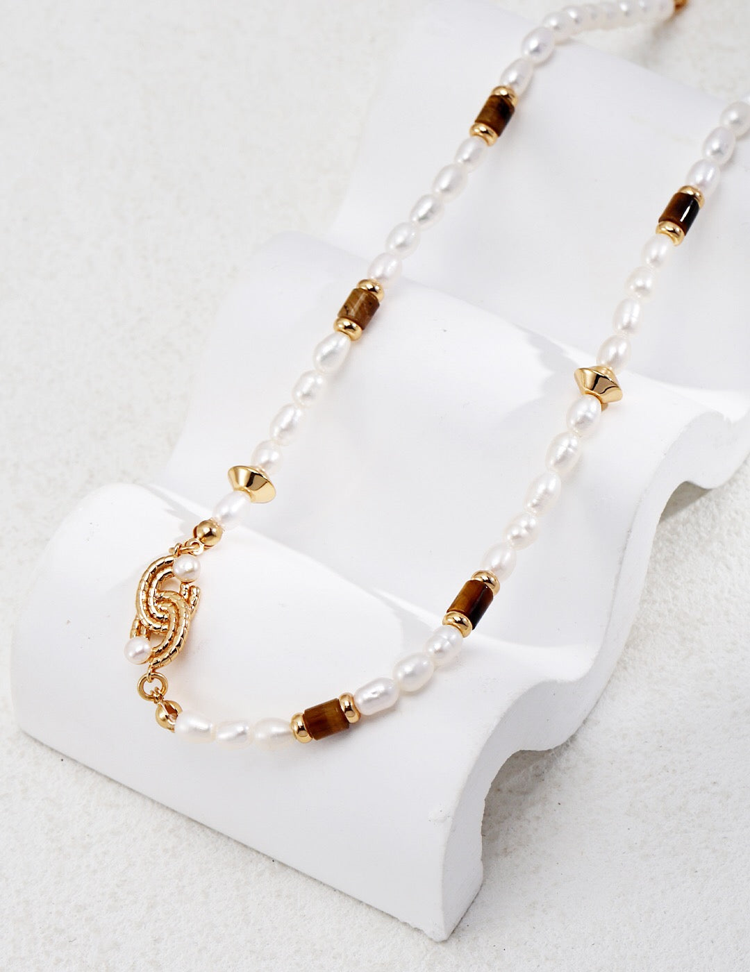 A handmade Natural Pearl with Tiger Eye Knot Necklace featuring freshwater pearls, tiger eye stones, and gold vermeil chain, elegantly displayed.