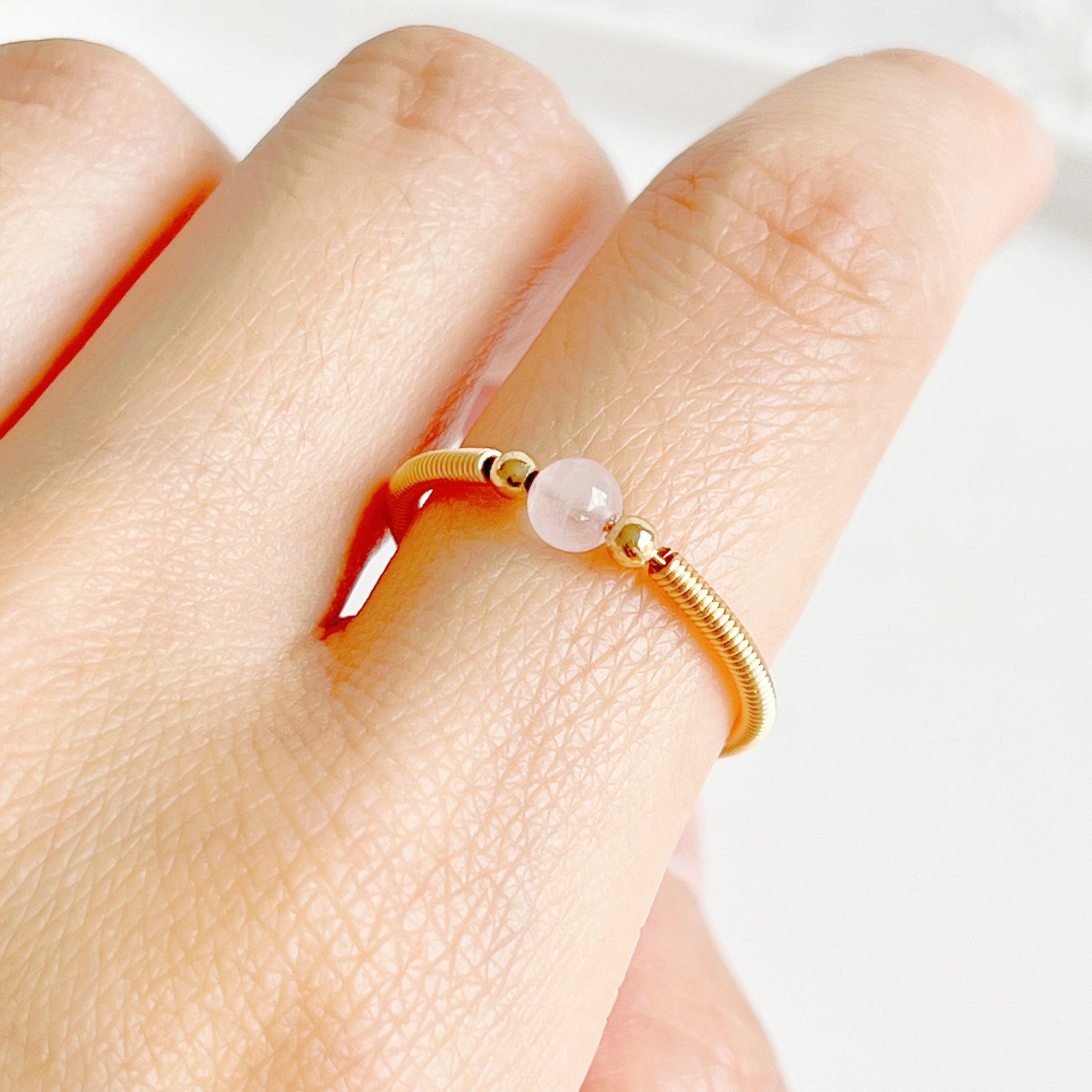 Natural Rose Quartz Bead Adjustable Ring featuring a 4mm pink crystal bead on gold-plated bronze wire, elegantly handcrafted.
