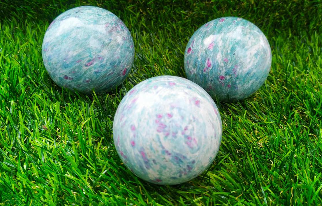 Natural Ruby Zosite Sphere Round Crystal Ball with stand, showcasing vibrant red and green colors, symbolizing healing and energy.