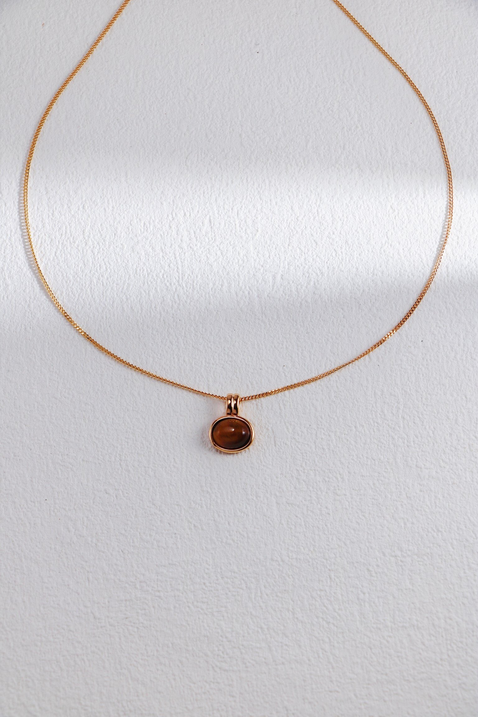 Natural Tiger Eye Stone and Red Agate Necklace featuring gold vermeil accents, showcasing its unique stones and elegant design.