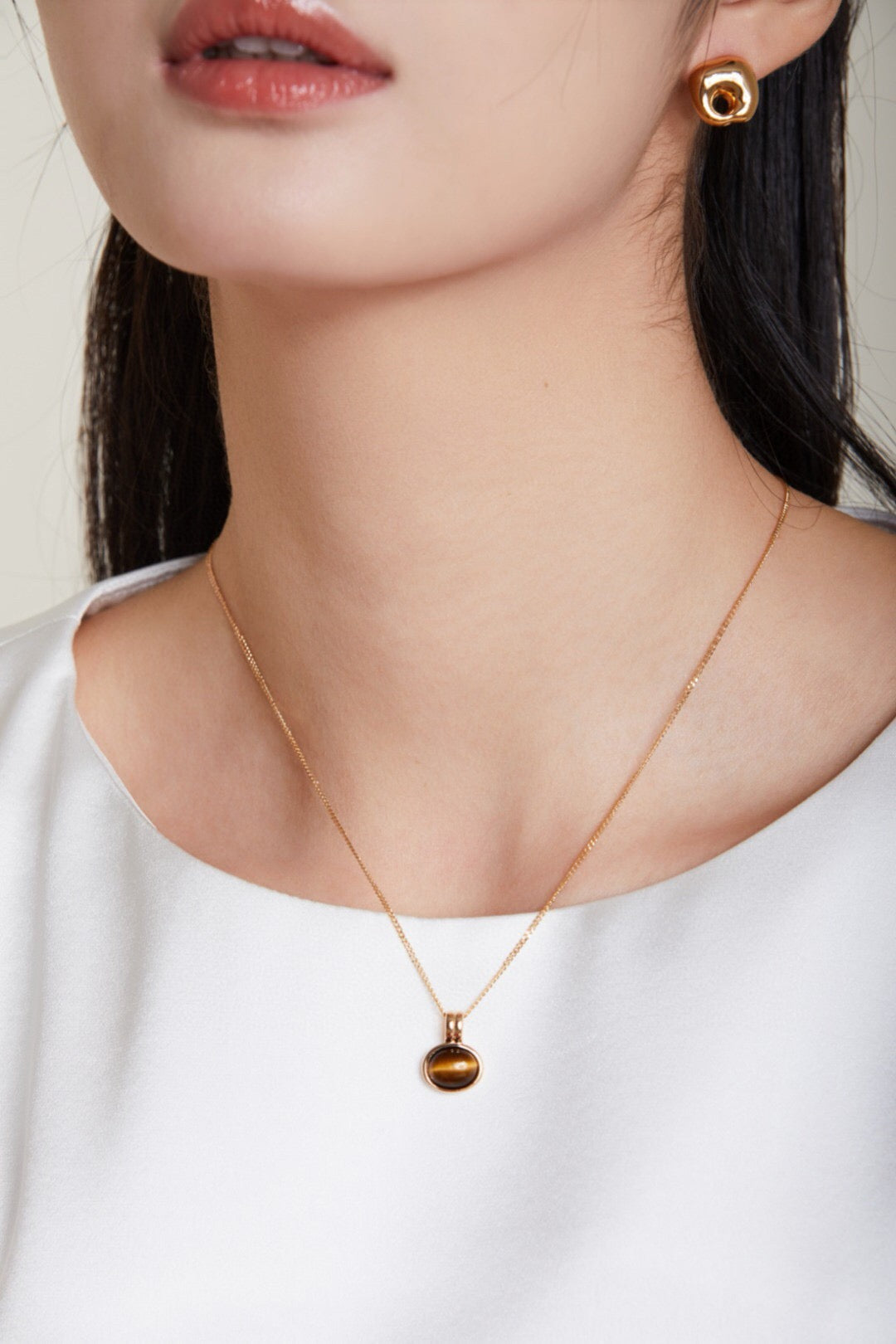 Natural Tiger Eye Stone and Red Agate Necklace featuring gold vermeil accents, showcasing its unique stones and elegant design.
