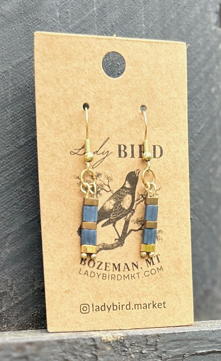 Navy blue earrings featuring gold or silver striped Tila beads, showcasing a stylish and bohemian design.