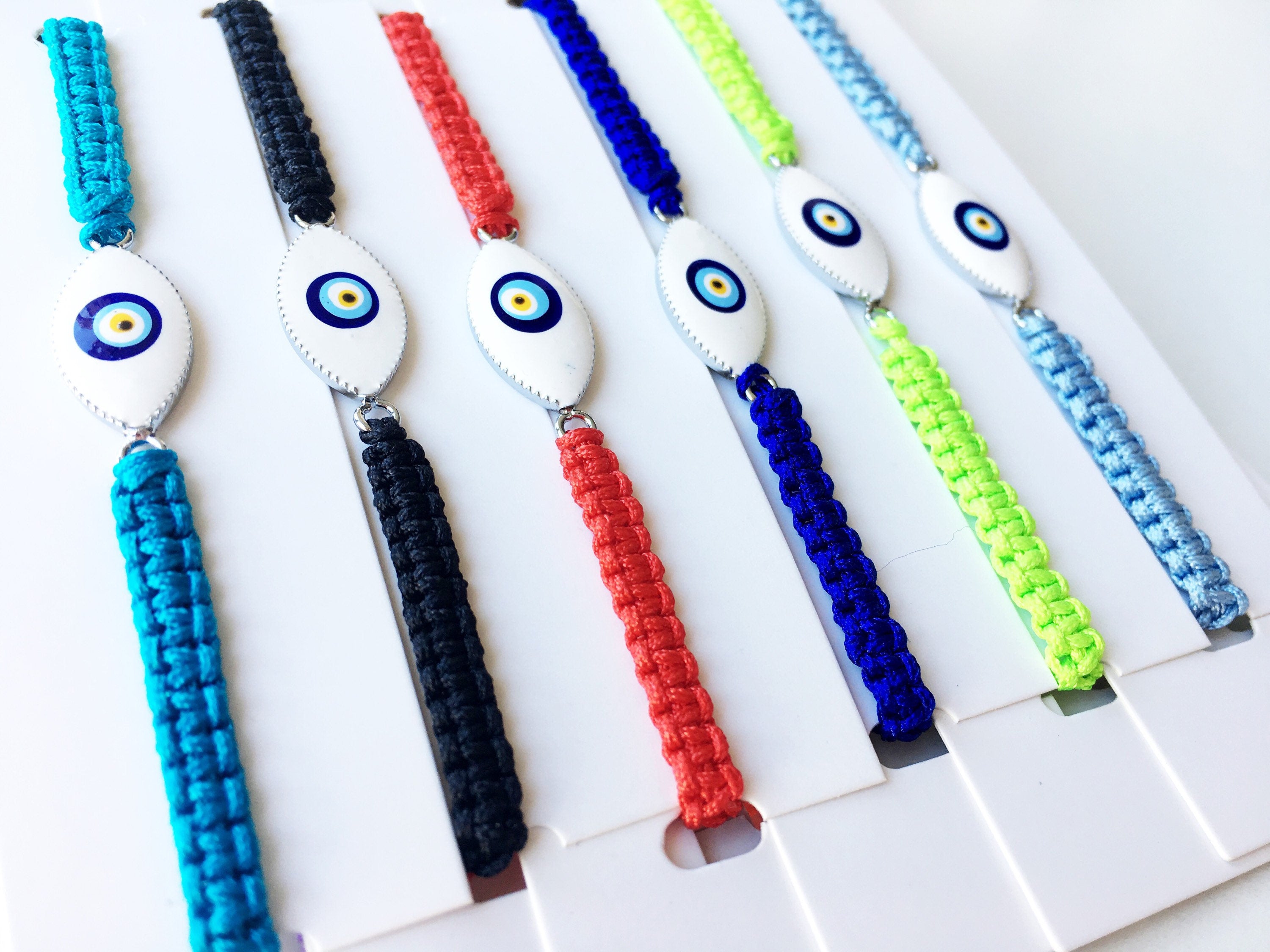 Handmade Nazar Boncuk Bracelet featuring an adjustable macrame design with an evil eye charm in black and white options.