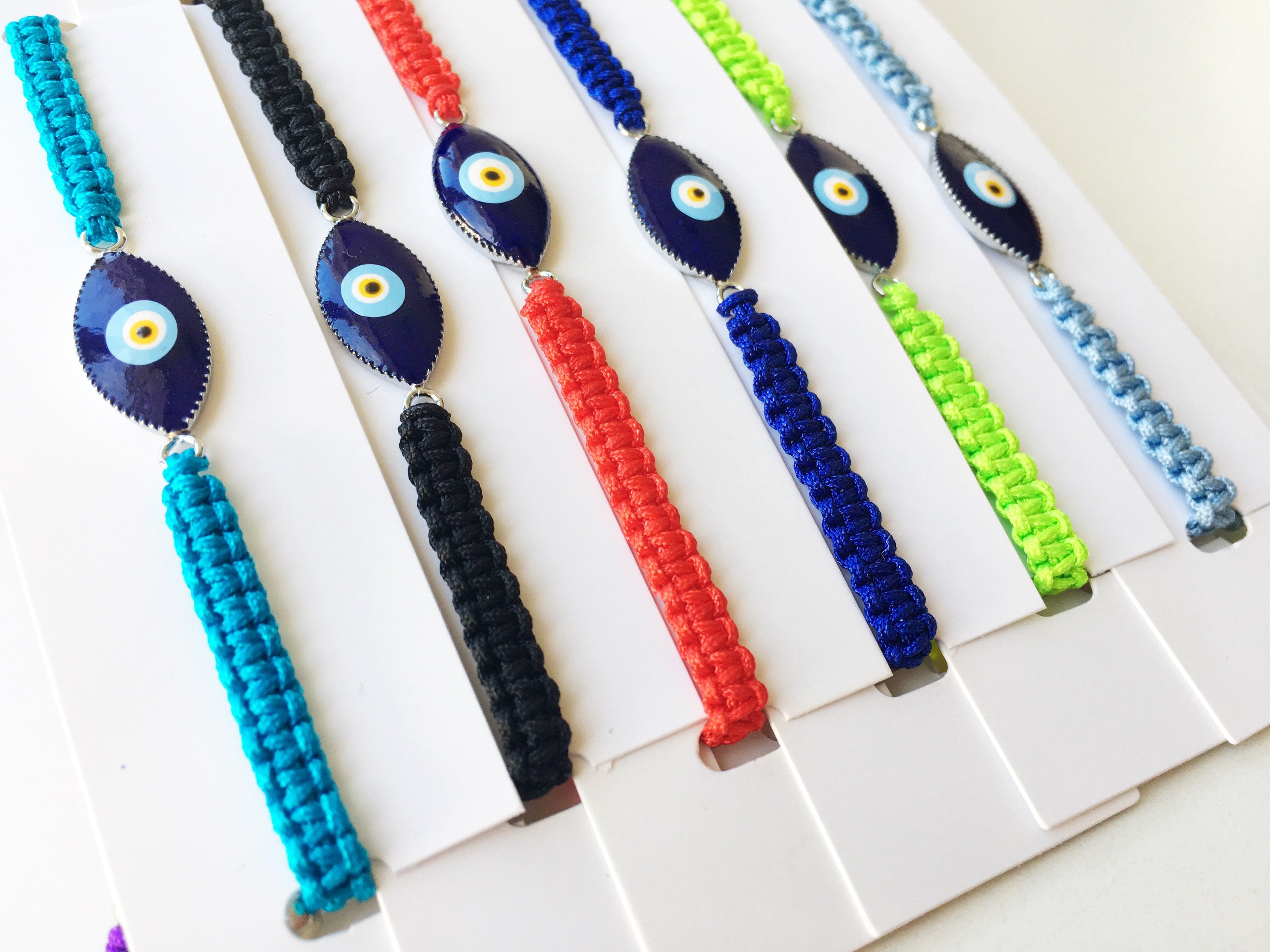 Handmade Nazar Boncuk Bracelet featuring an adjustable macrame design with an evil eye charm in black and white options.