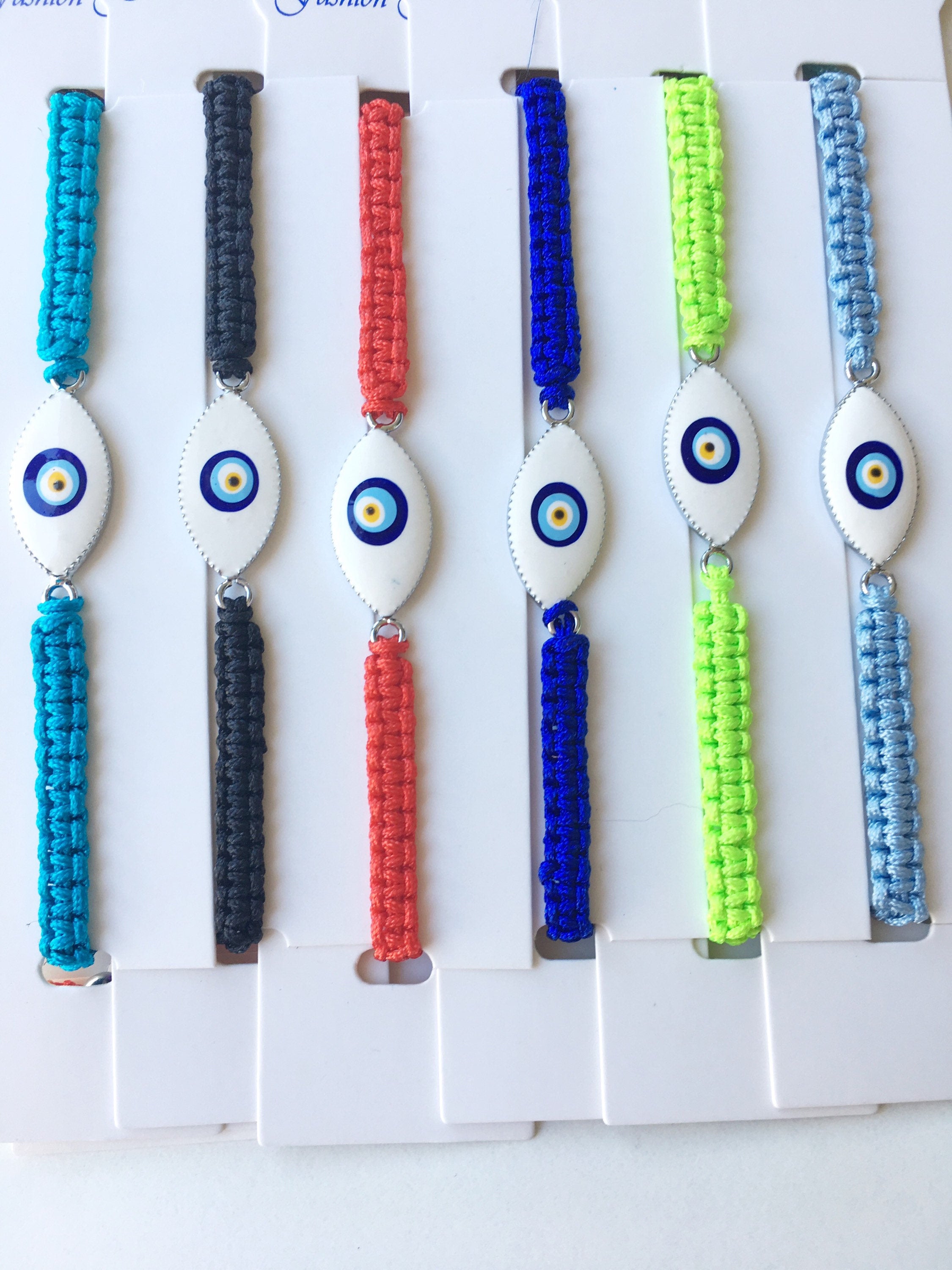 Handmade Nazar Boncuk Bracelet featuring an adjustable macrame design with an evil eye charm in black and white options.