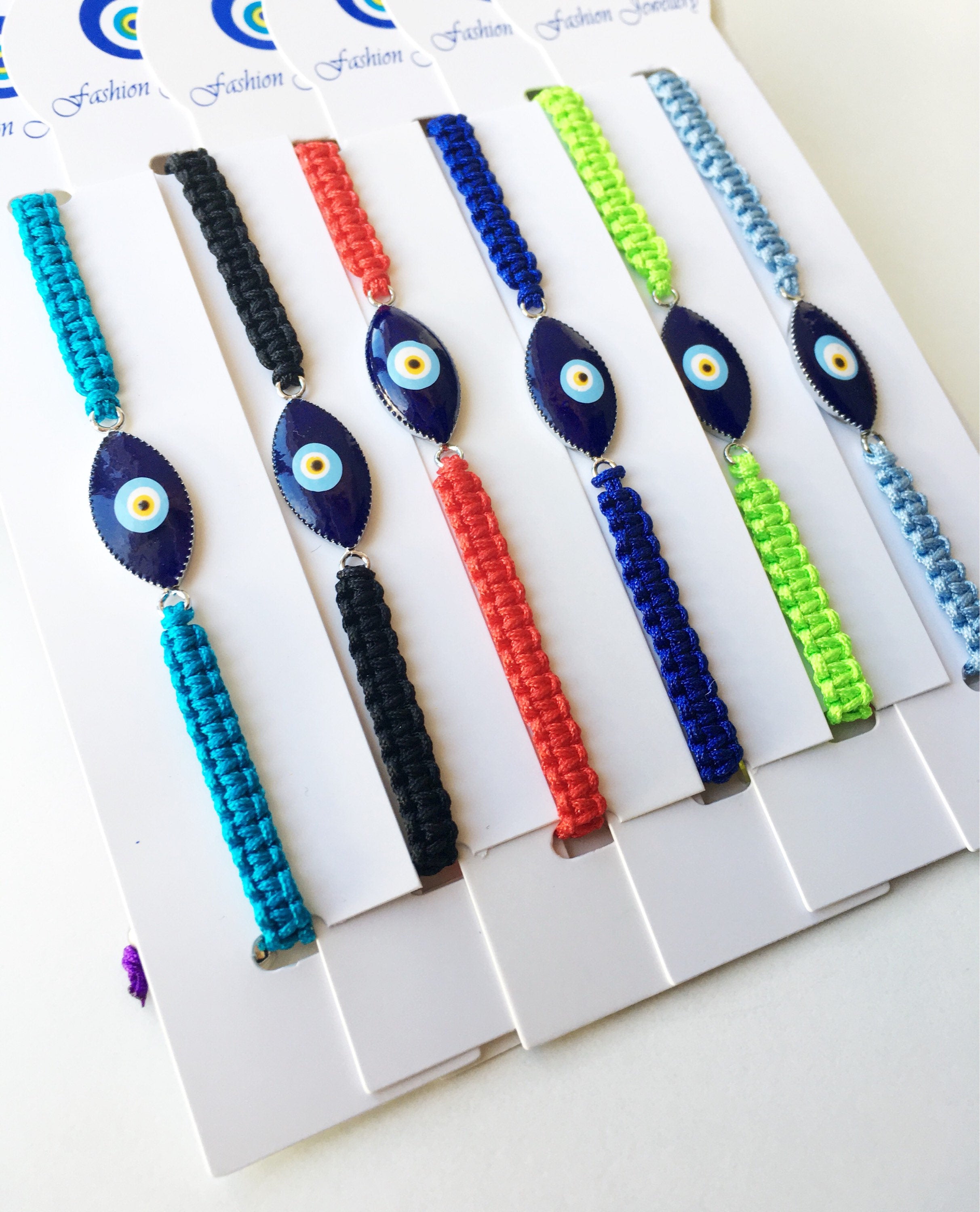 Handmade Nazar Boncuk Bracelet featuring an adjustable macrame design with an evil eye charm in black and white options.