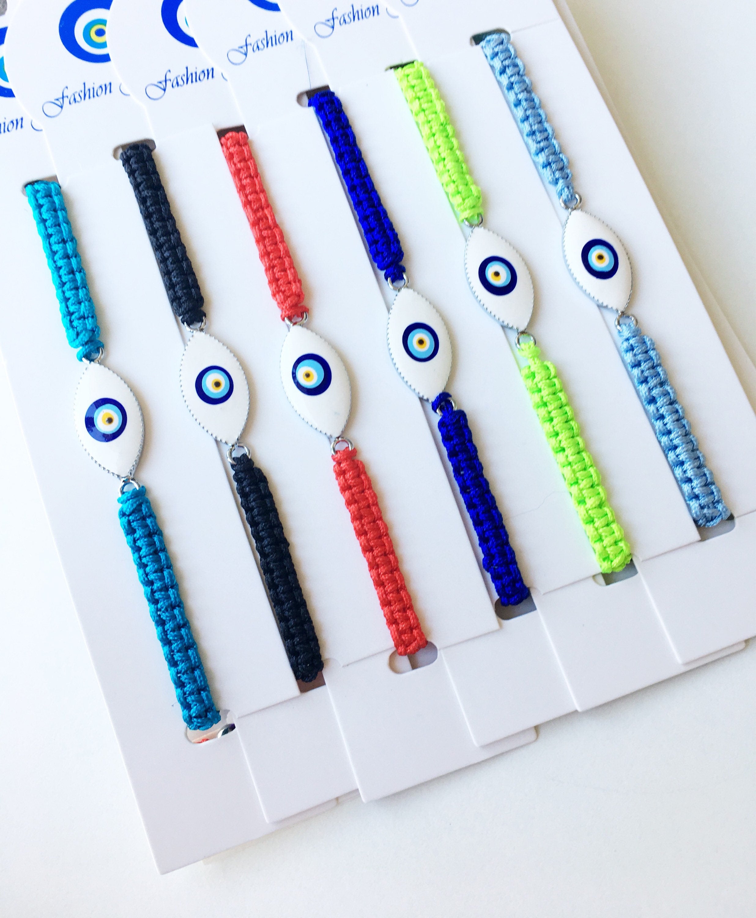 Handmade Nazar Boncuk Bracelet featuring an adjustable macrame design with an evil eye charm in black and white options.