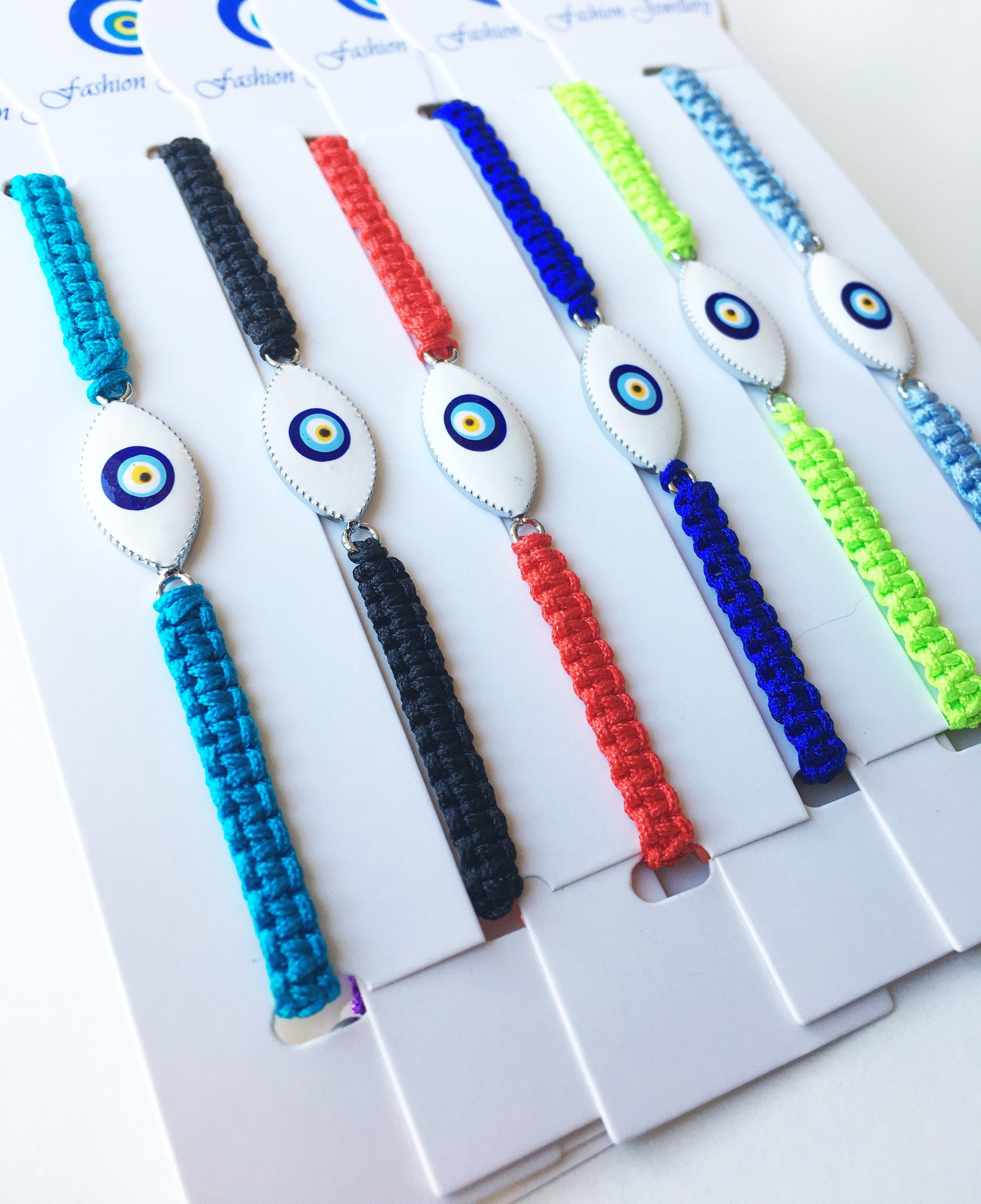 Handmade Nazar Boncuk Bracelet featuring an adjustable macrame design with an evil eye charm in black and white options.