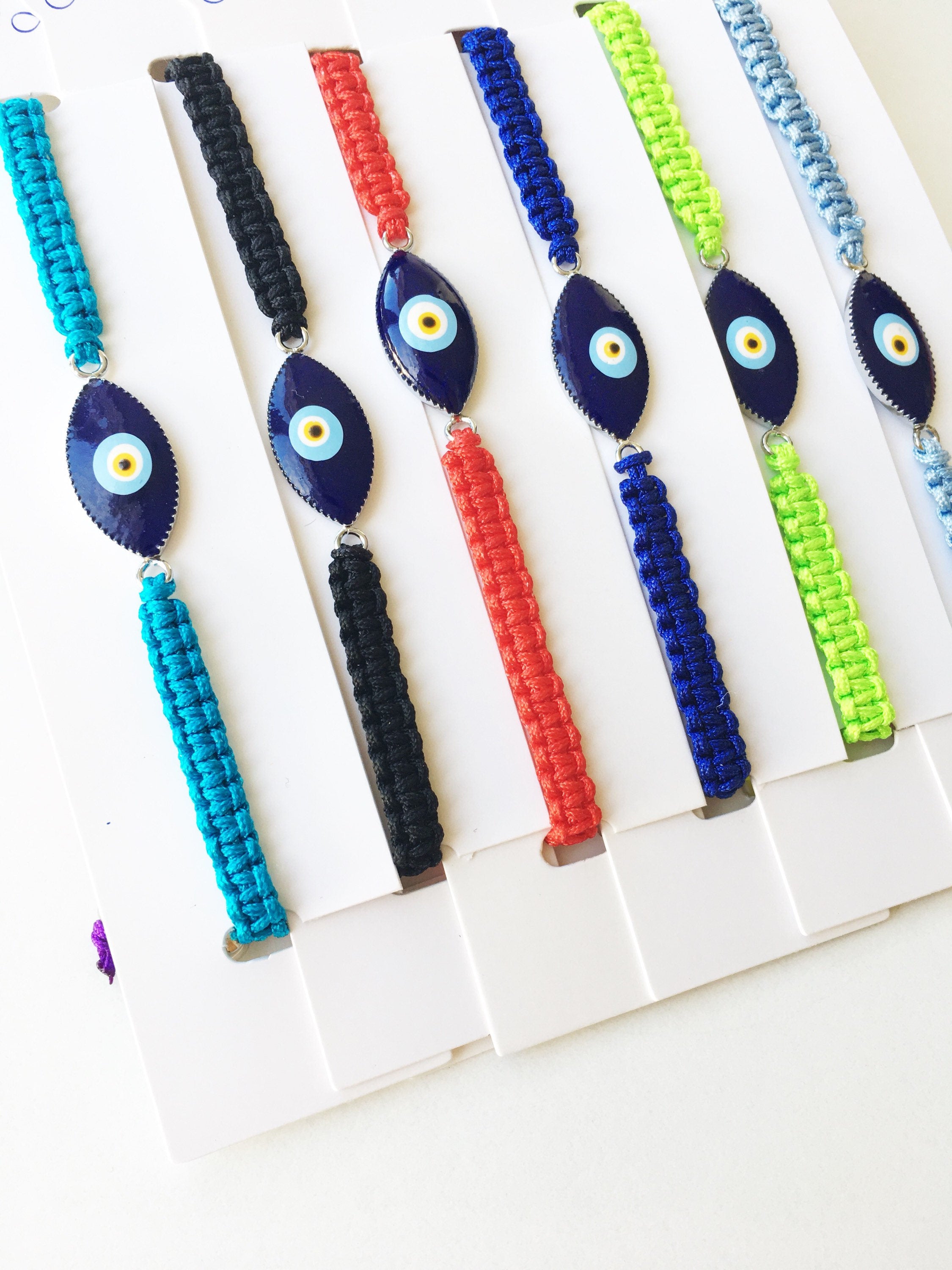 Handmade Nazar Boncuk Bracelet featuring an adjustable macrame design with an evil eye charm in black and white options.