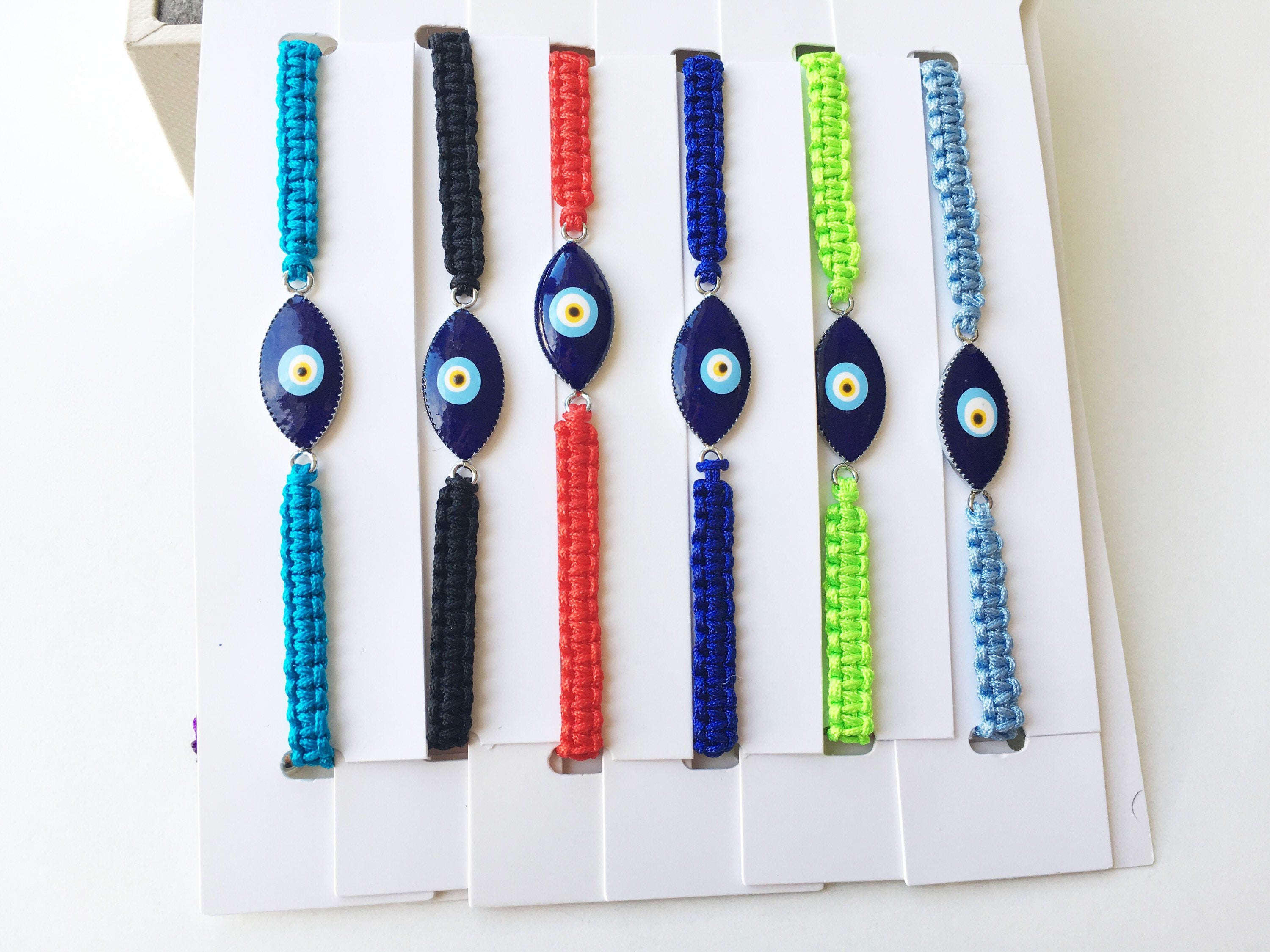 Handmade Nazar Boncuk Bracelet featuring an adjustable macrame design with an evil eye charm in black and white options.