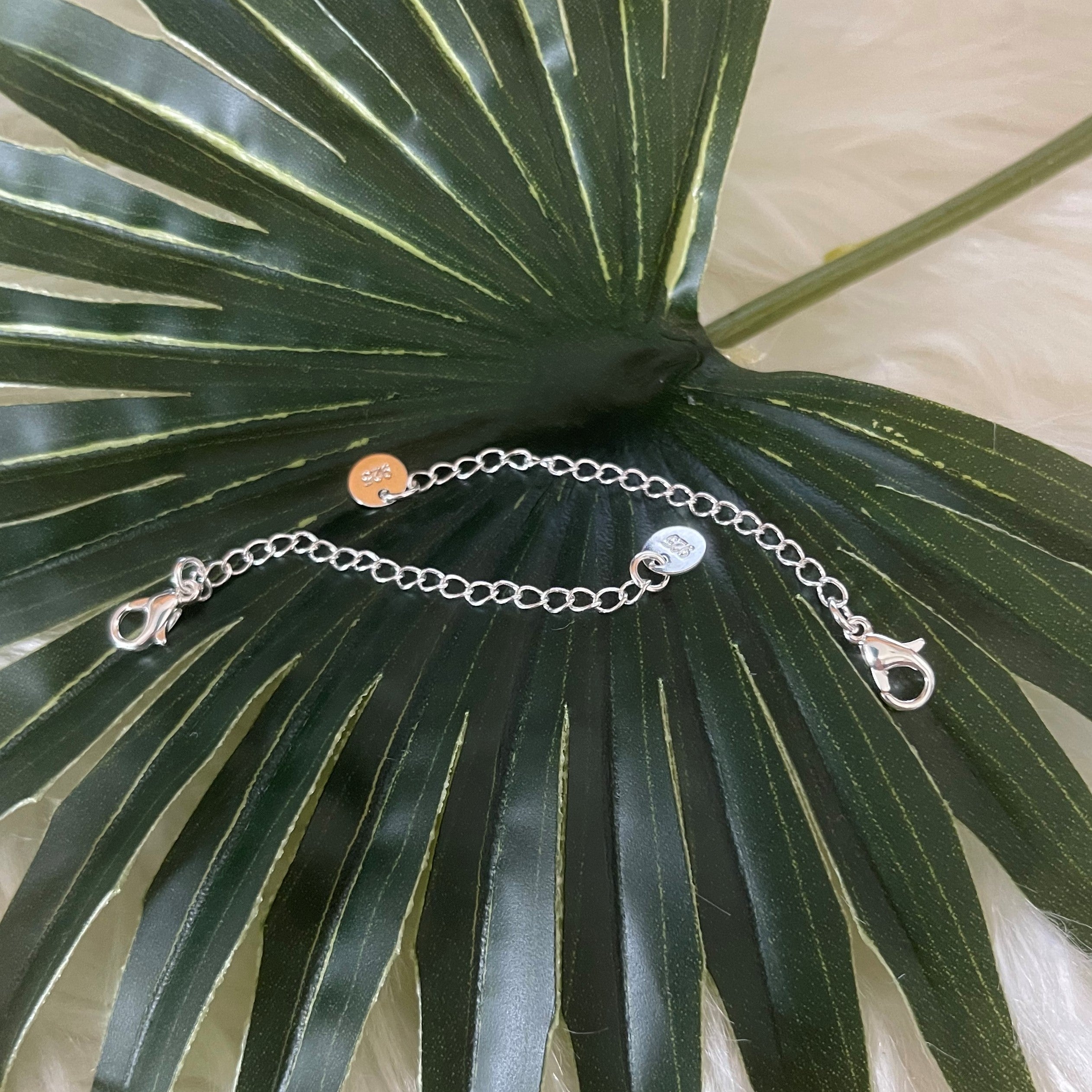 A 2-inch necklace and bracelet extender made of 925 Sterling Silver and 18K Gold Fill, showcasing its elegant design and quality craftsmanship.