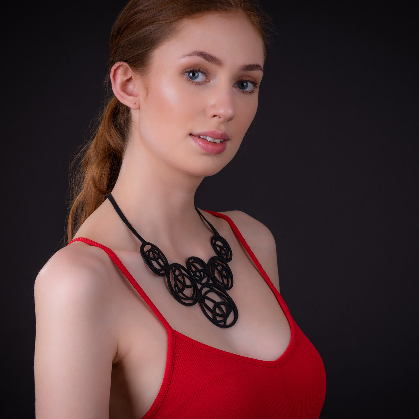 Neptune Black Necklace made from reclaimed rubber inner tubes, featuring a modern design and lightweight construction.