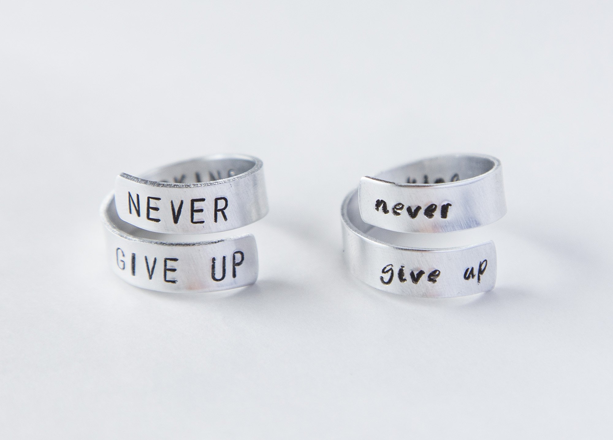 Never Fucking Give Up Ring, adjustable aluminum ring with hand-stamped letters, symbolizing cancer survival and victory.