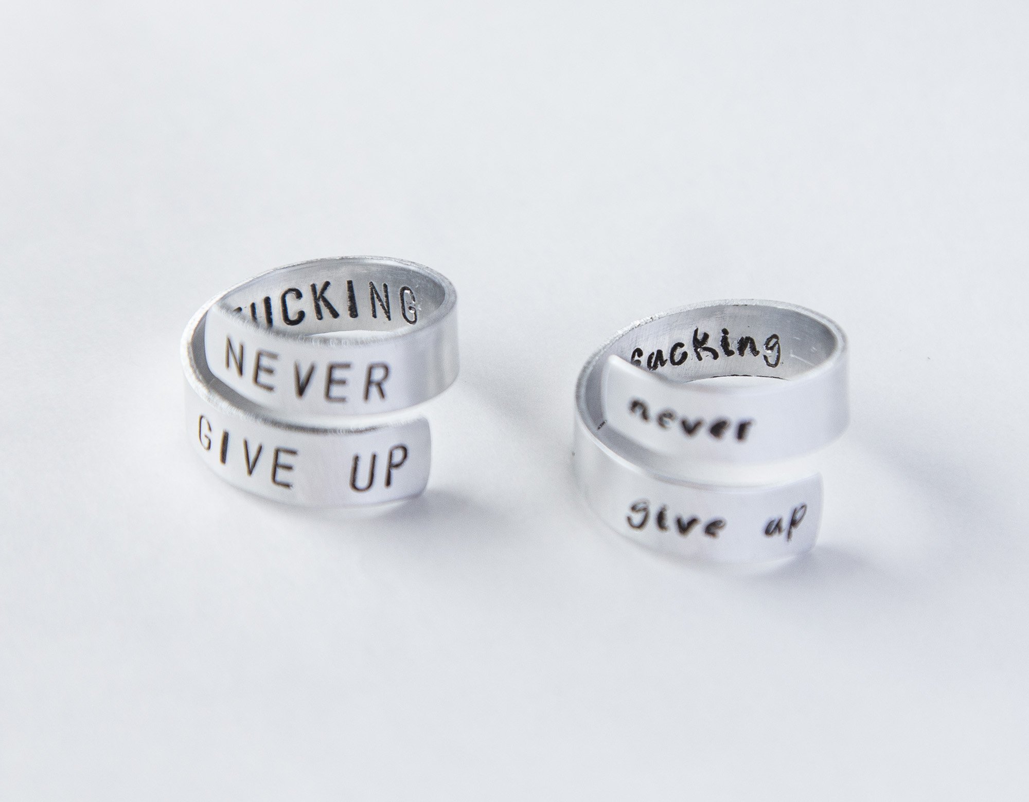 Never Fucking Give Up Ring, adjustable aluminum ring with hand-stamped letters, symbolizing cancer survival and victory.