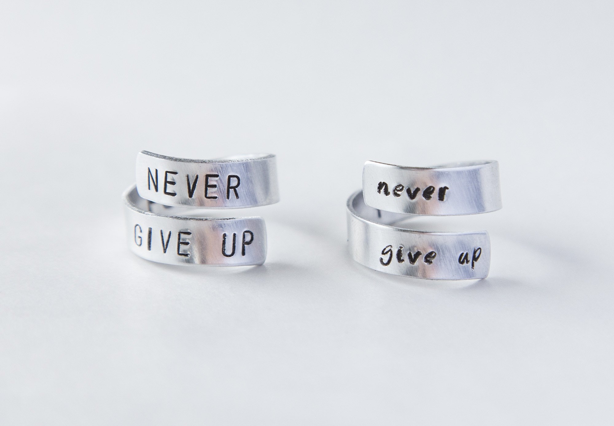 Never Fucking Give Up Ring, adjustable aluminum ring with hand-stamped letters, symbolizing cancer survival and victory.
