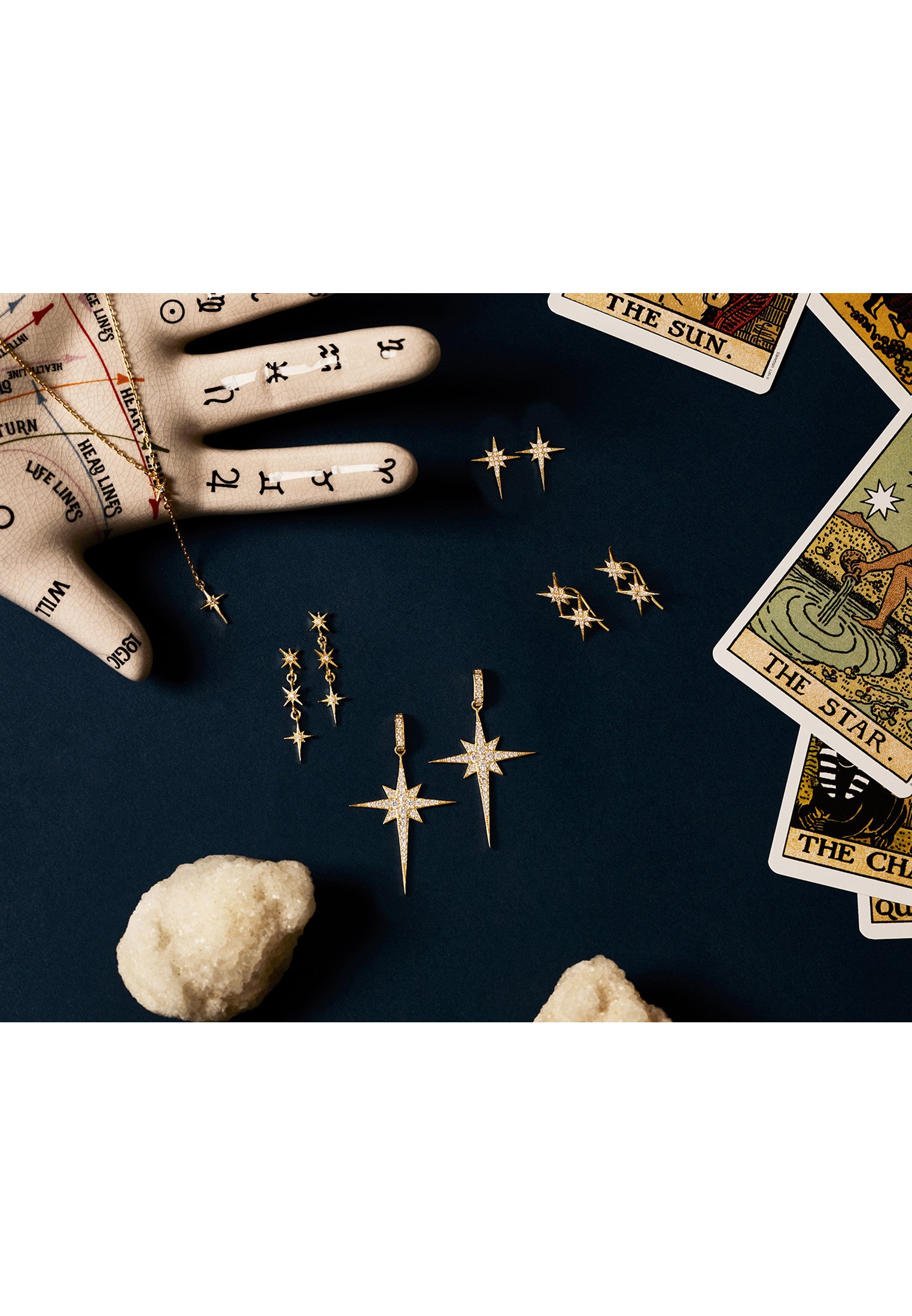 North Star Burst Large Drop Earrings in Gold featuring a star burst design with white zirconia, crafted from sterling silver and gold.